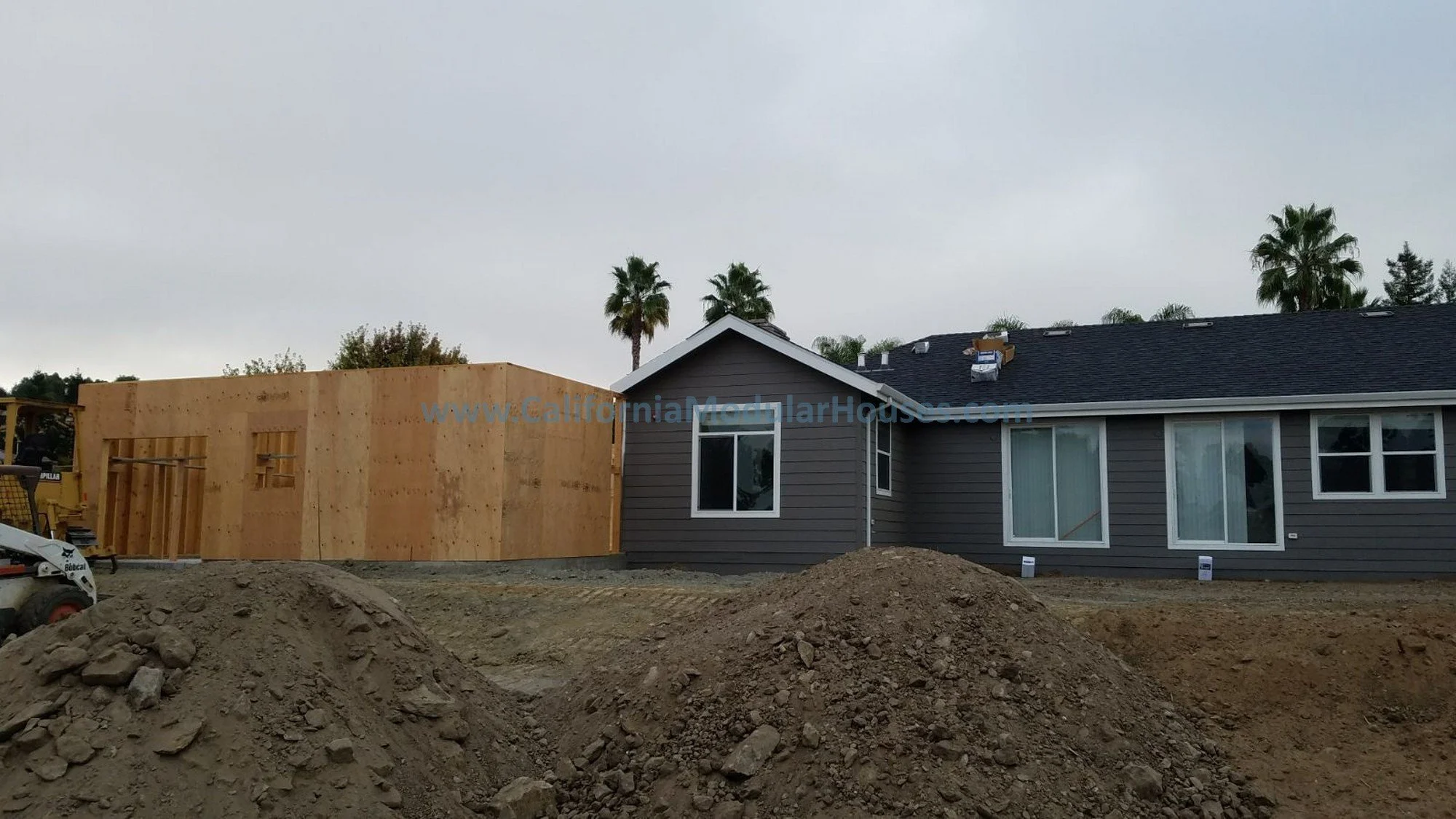 This Factory Built Housing home model was built and installed on the foundation and this shows the site built garage built after the home is already there and almost finished.  