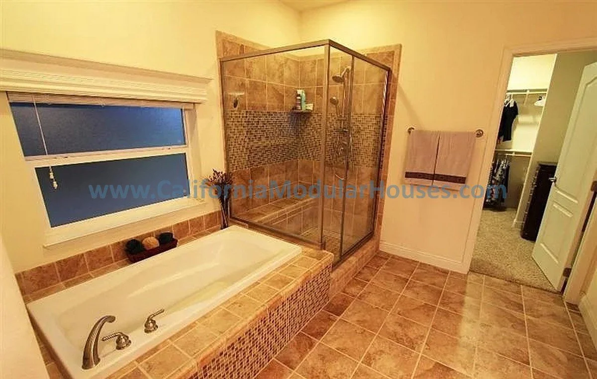 Bathroom with a bathtub, glass-enclosed shower, small closet, and window with blinds.