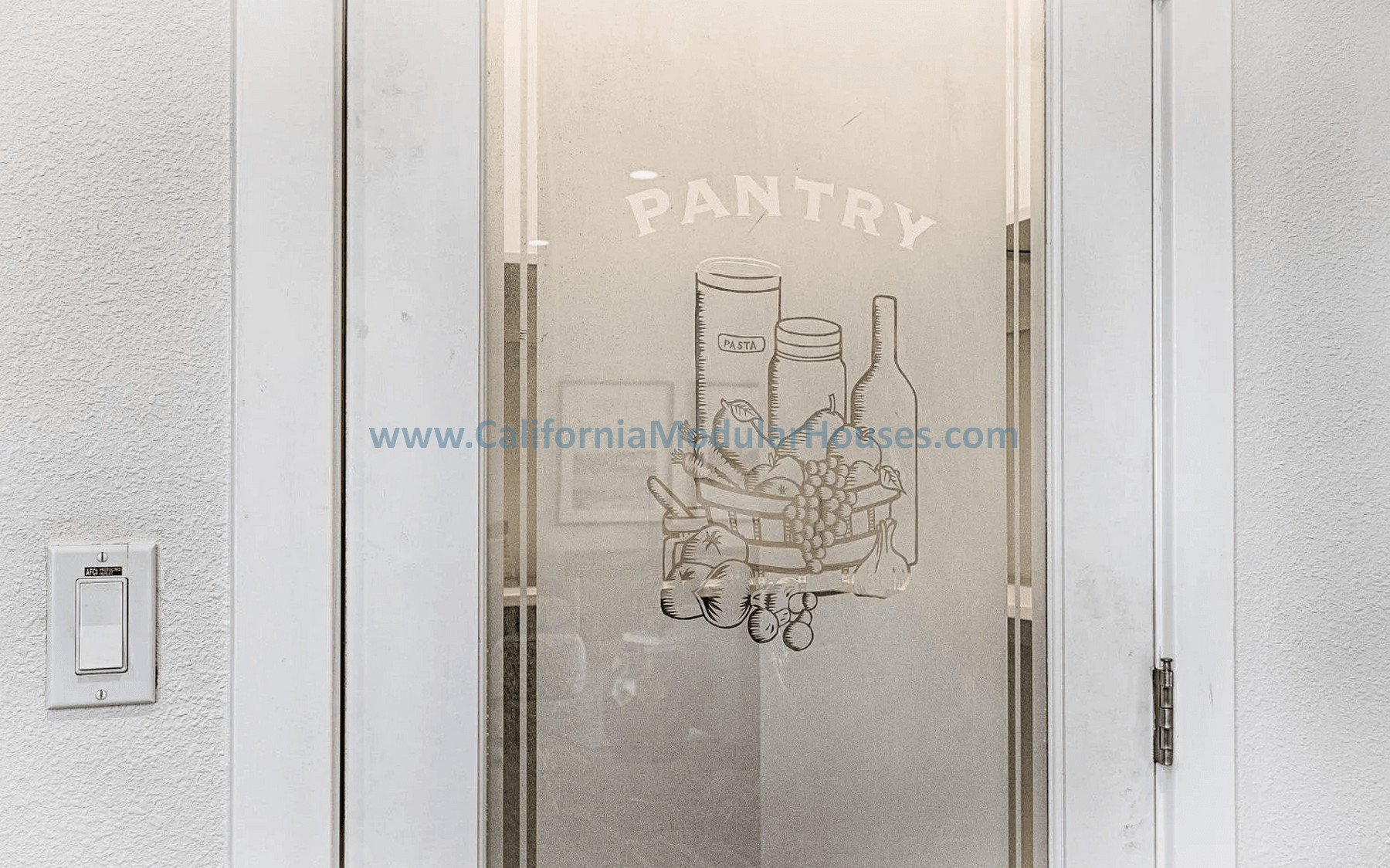 Glass door with a hand-drawn illustration of pantry items, including jars and bottles, and the word 'PANTRY' written above. Website URL printed across the middle of the illustration.
