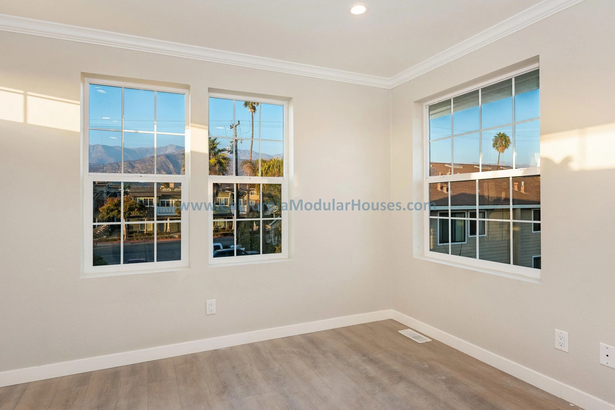 French oak floors of a prefab modular two-story home, bright light windows.