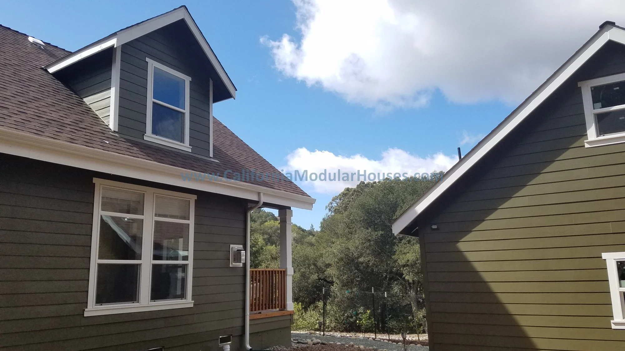 This is a close-up of this Factory Built Home showing the detailing of the lap siding of both the prefab house and the site built garage and how beautifully they match.  California South San Francisco Bay area.  