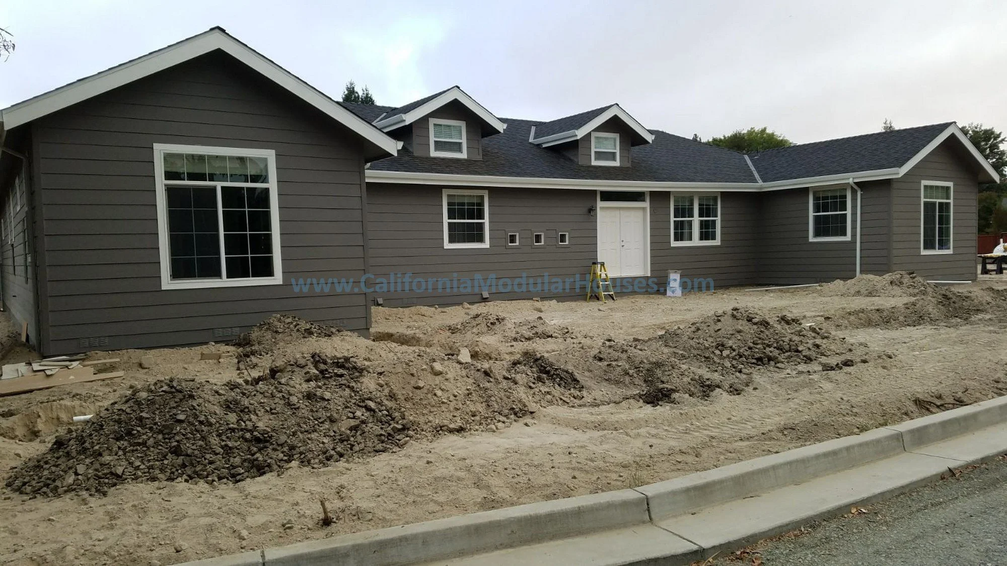 This is the front of the modular home once, the roof has been completed, before the door has been painted, rockwork and the garage are not yet completed.  