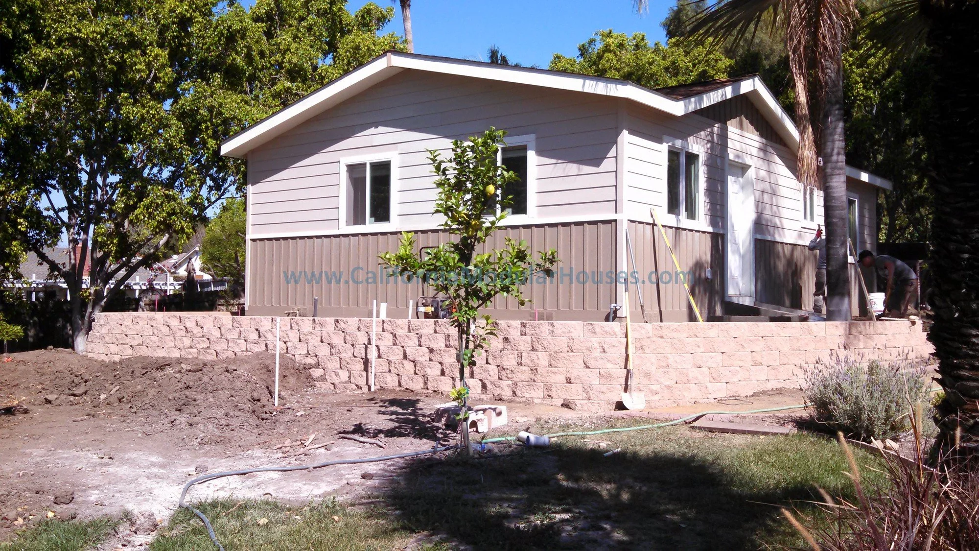This is an ADU on a raised concrete stem wall foundation built in the city of Villa Park, Orange County, California.  There is a retaining wall based on the small slope of the property.  