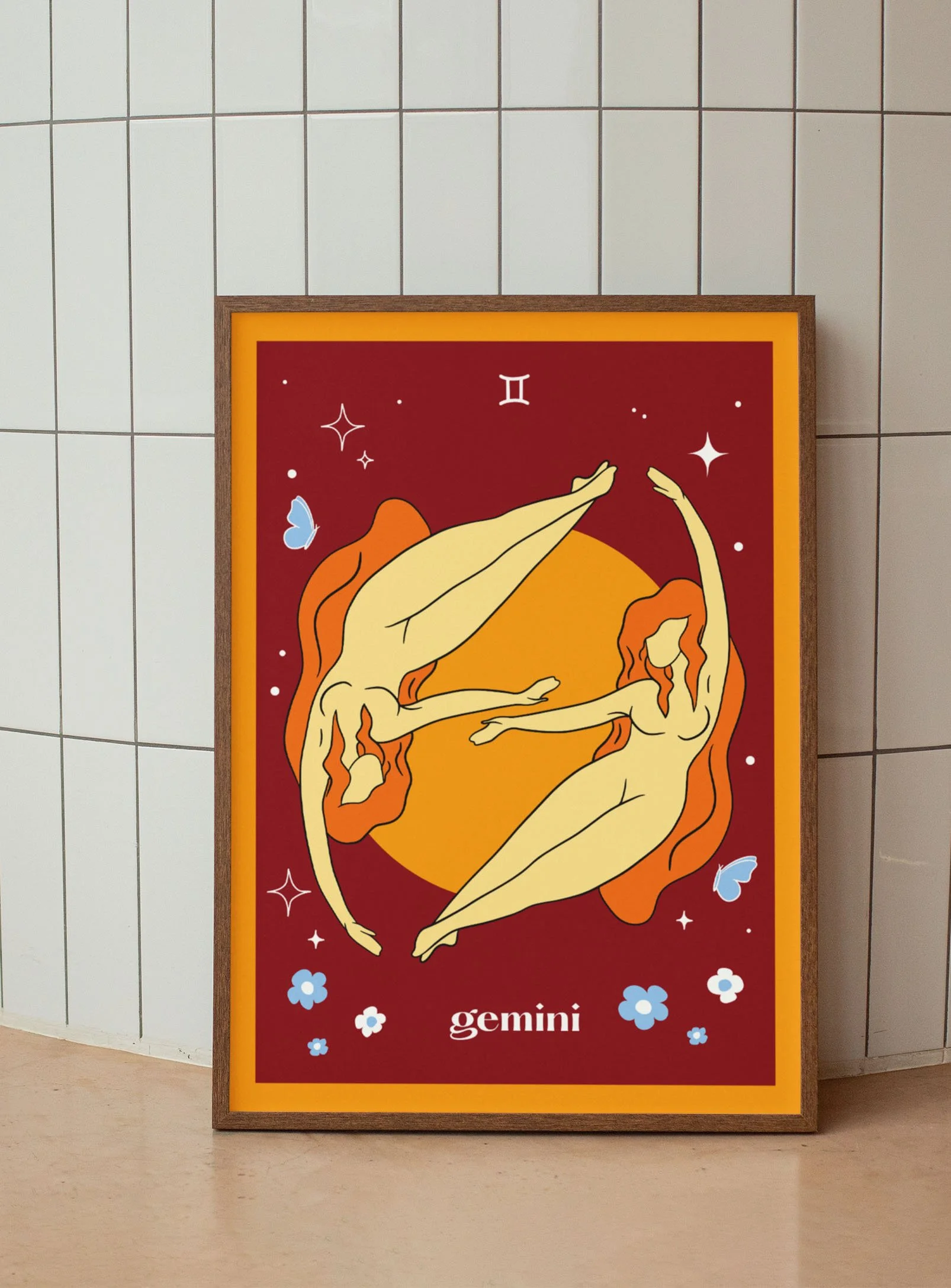 Decorative poster of two mirrored Gemini zodiac signs depicted as stylized women with flowing orange hair, against a deep red background with stars and flowers.