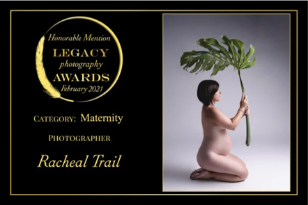 A pregnant woman kneeling on the ground holding a large leaf.