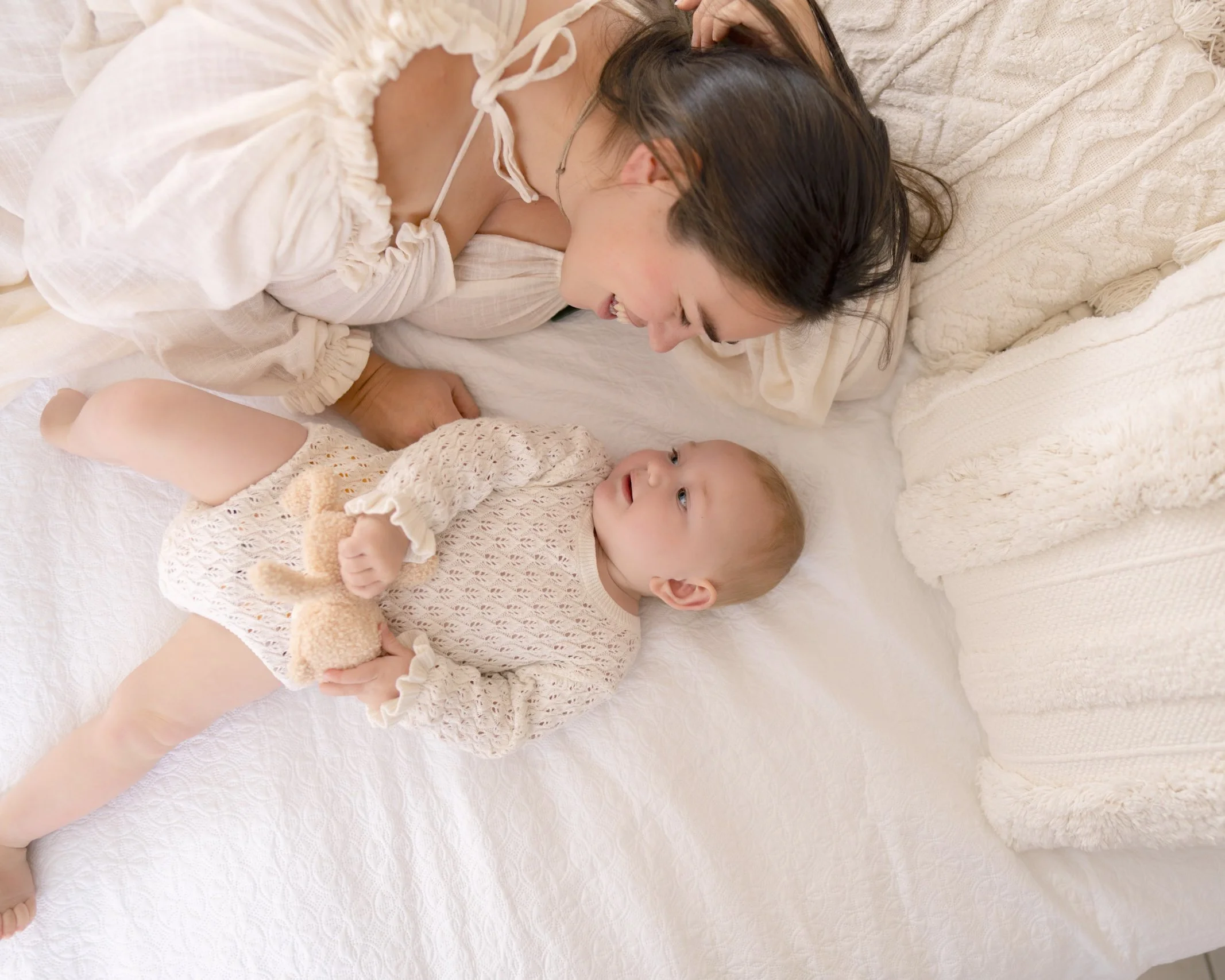 Mum sharing a relaxed moment with her baby during a soft lifestyle milestone photography session in South Auckland.