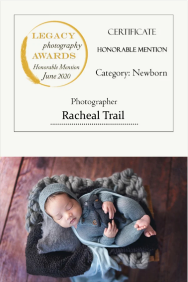 Certificate of Honorable Mention for Newborn Category awarded to Racheal Trail, with a photo of a sleeping newborn baby in a knitted hat and onesie, lying on a blanket.