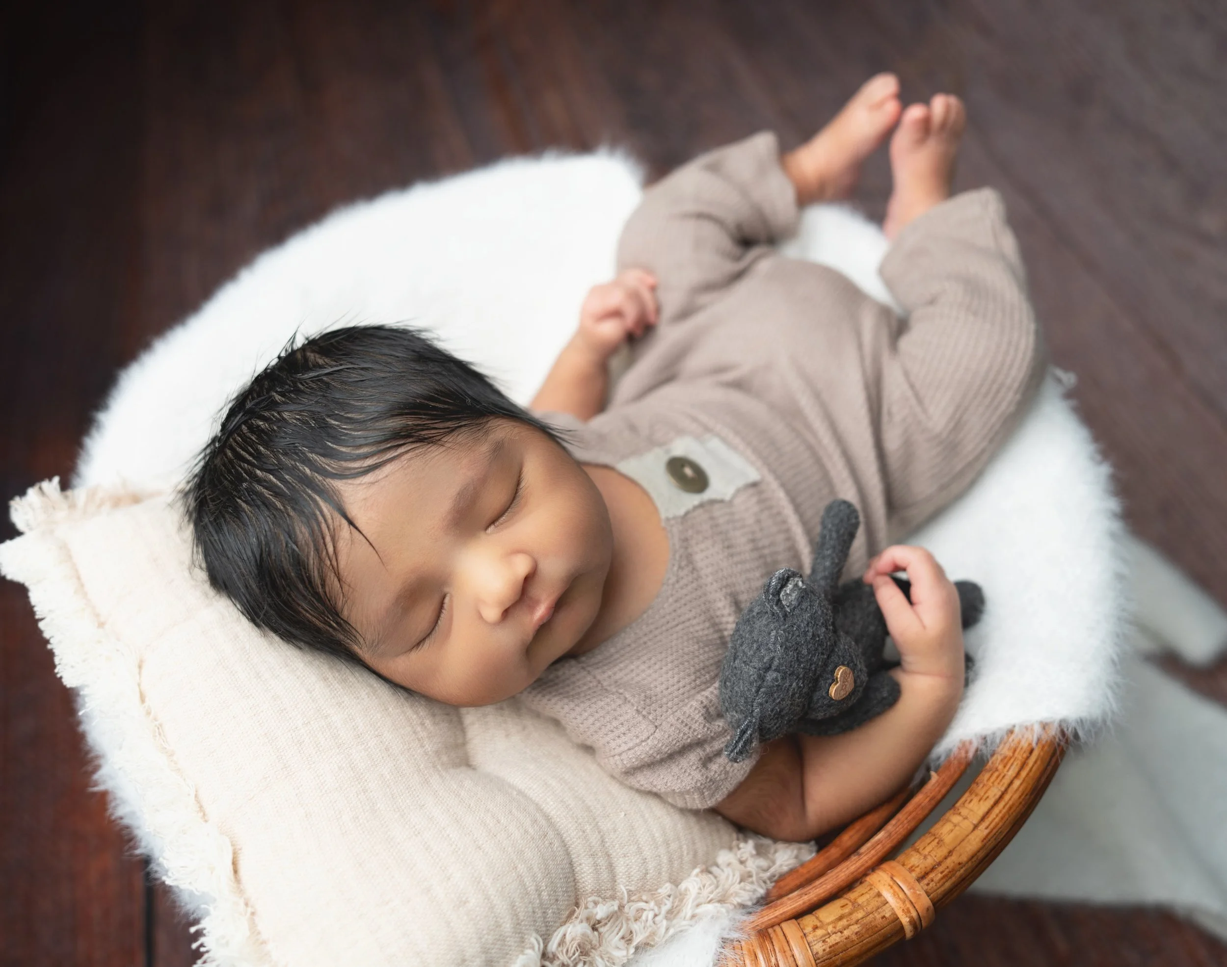 Close-up detail of a sleeping newborn baby safely posed during a West Auckland mobile session.