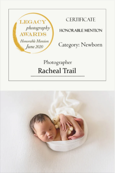 Certificate of honorable mention for newborn photography awarded to Racheal Trail in June 2020, with an image of a sleeping newborn baby in a white bowl. The baby is holding a small plush toy, surrounded by steam.