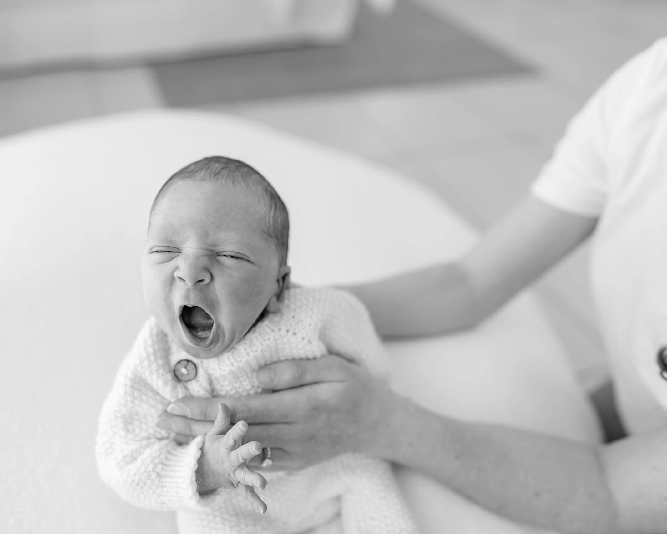 Newborn baby yawning during a relaxed guided lifestyle newborn photography session
