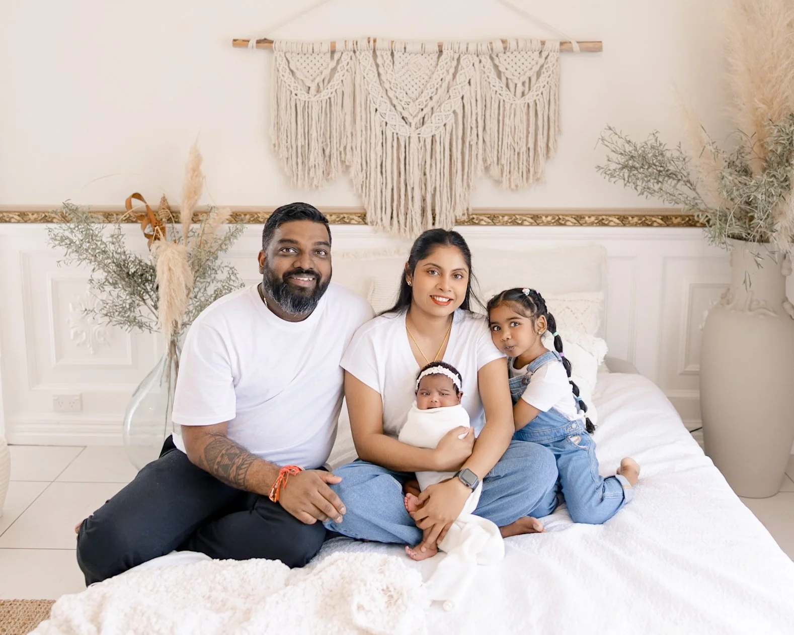 Family with newborn baby and older sibling during the studio portion of an Auckland split newborn photography session