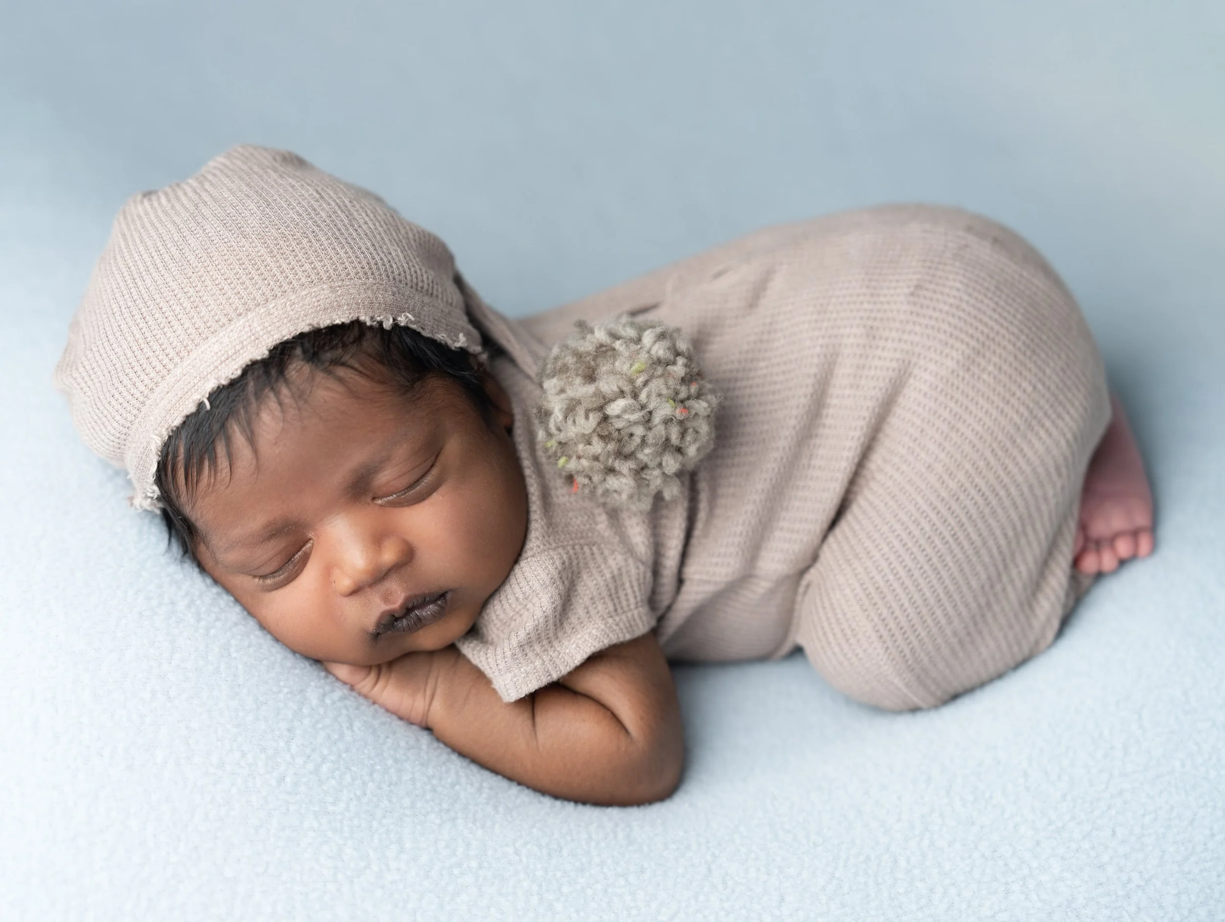 Studio-quality newborn boy portrait using a mobile photography setup in a family home in Hobsonville.