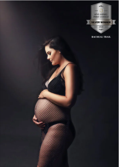 A pregnant woman in fishnet clothing posing in profile against a dark background, with an AFNS Award Silver Winner badge and the name Racheal Trail in the top right corner.
