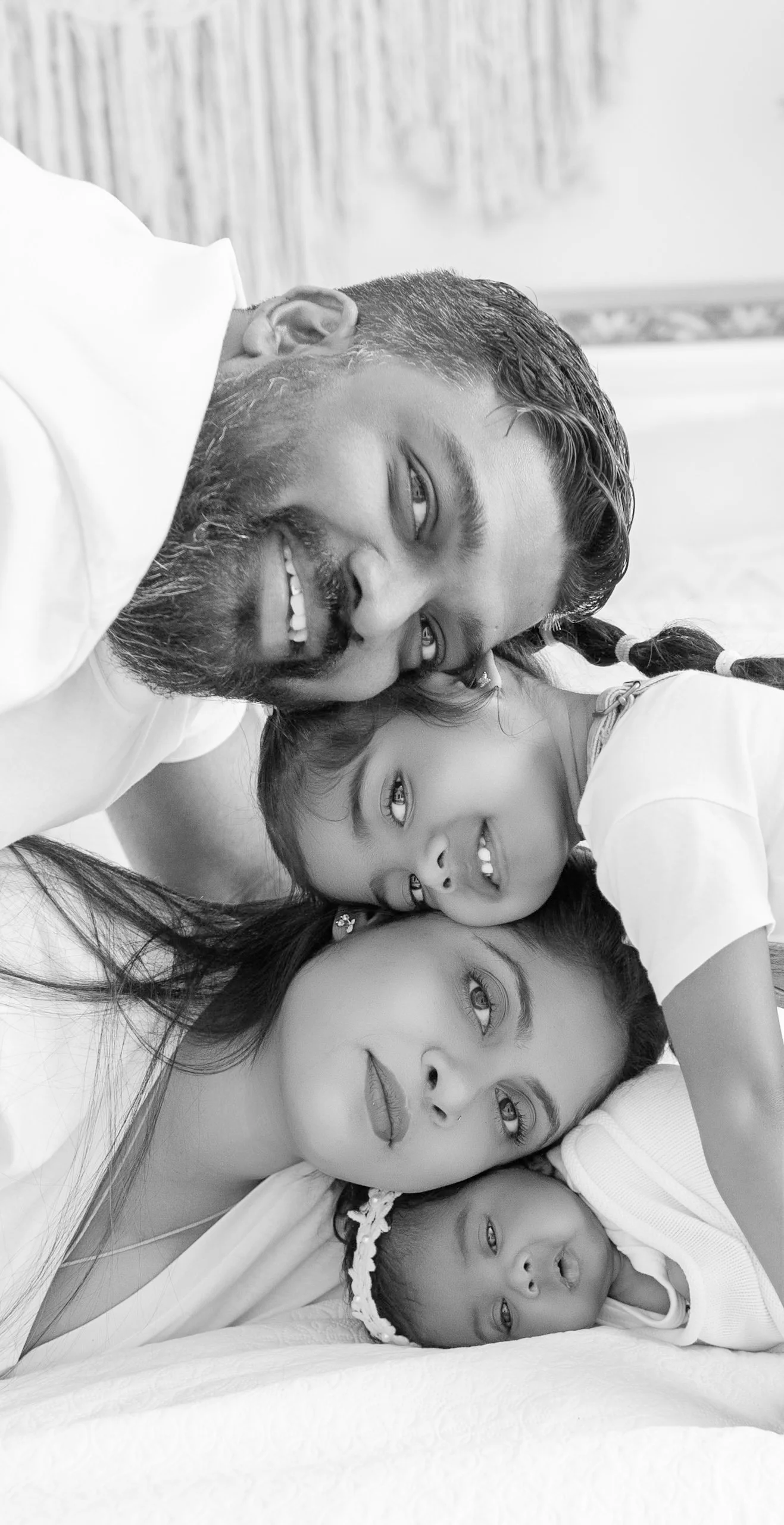 Family cuddling with their newborn baby during an Auckland lifestyle newborn session