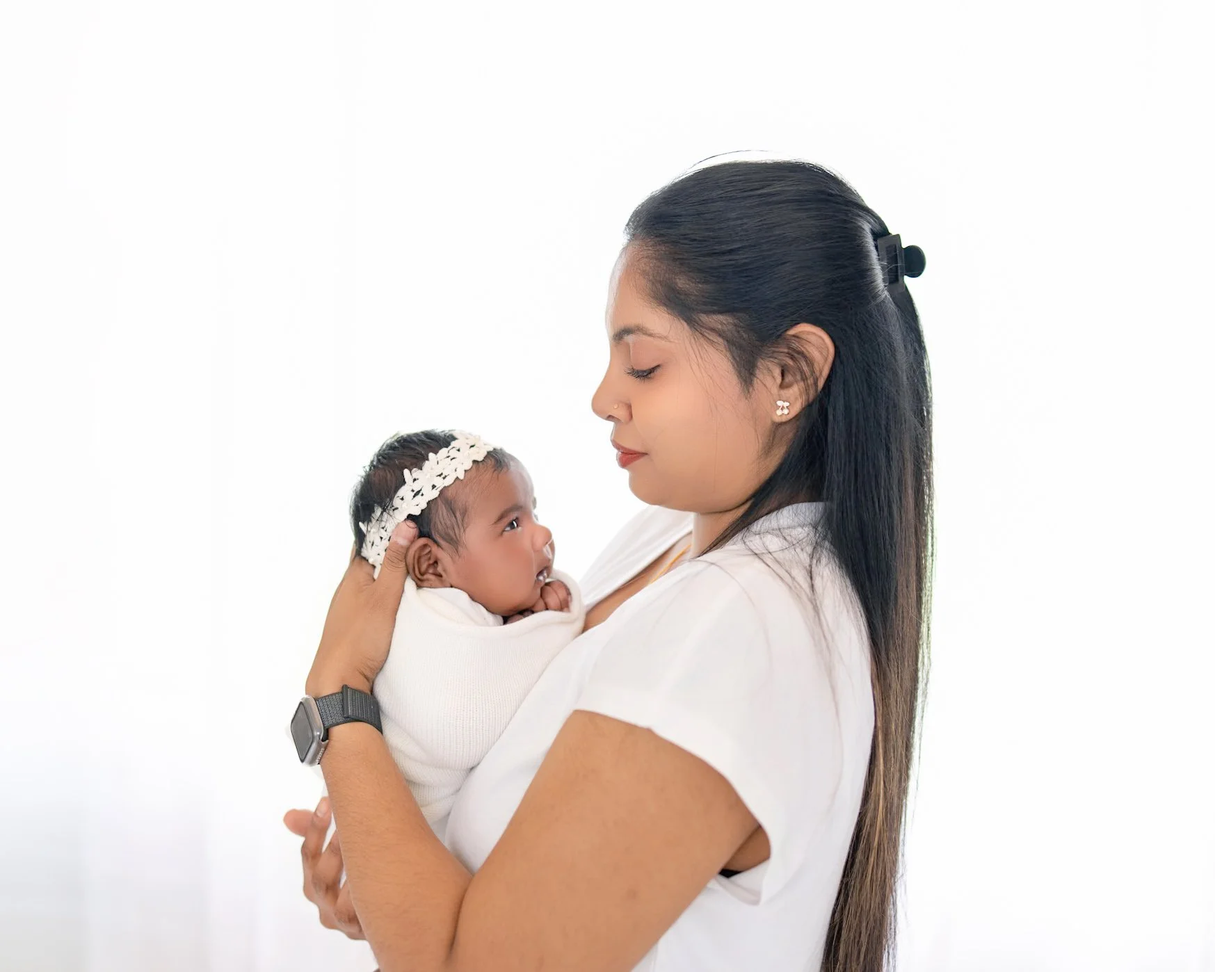 Mum holding her baby during the studio part of a split newborn photography session in Auckland