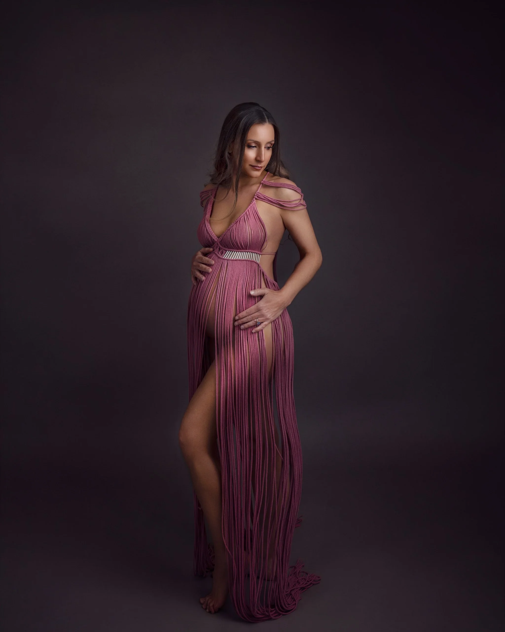 Pregnant woman posing in a pink gown during a studio maternity photography session in Auckland.