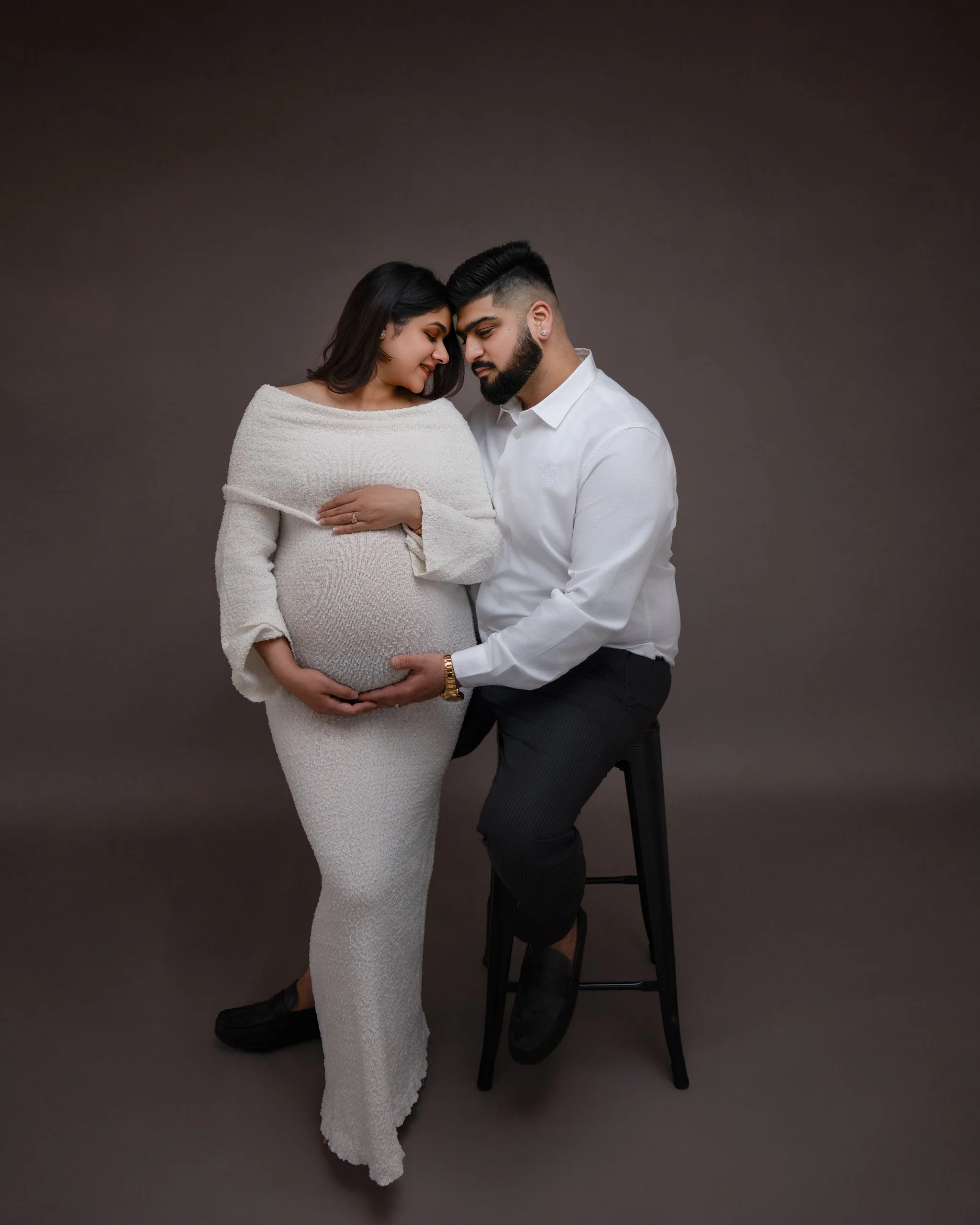  Pregnant couple photographed together in a timeless studio maternity portrait session in Auckland.