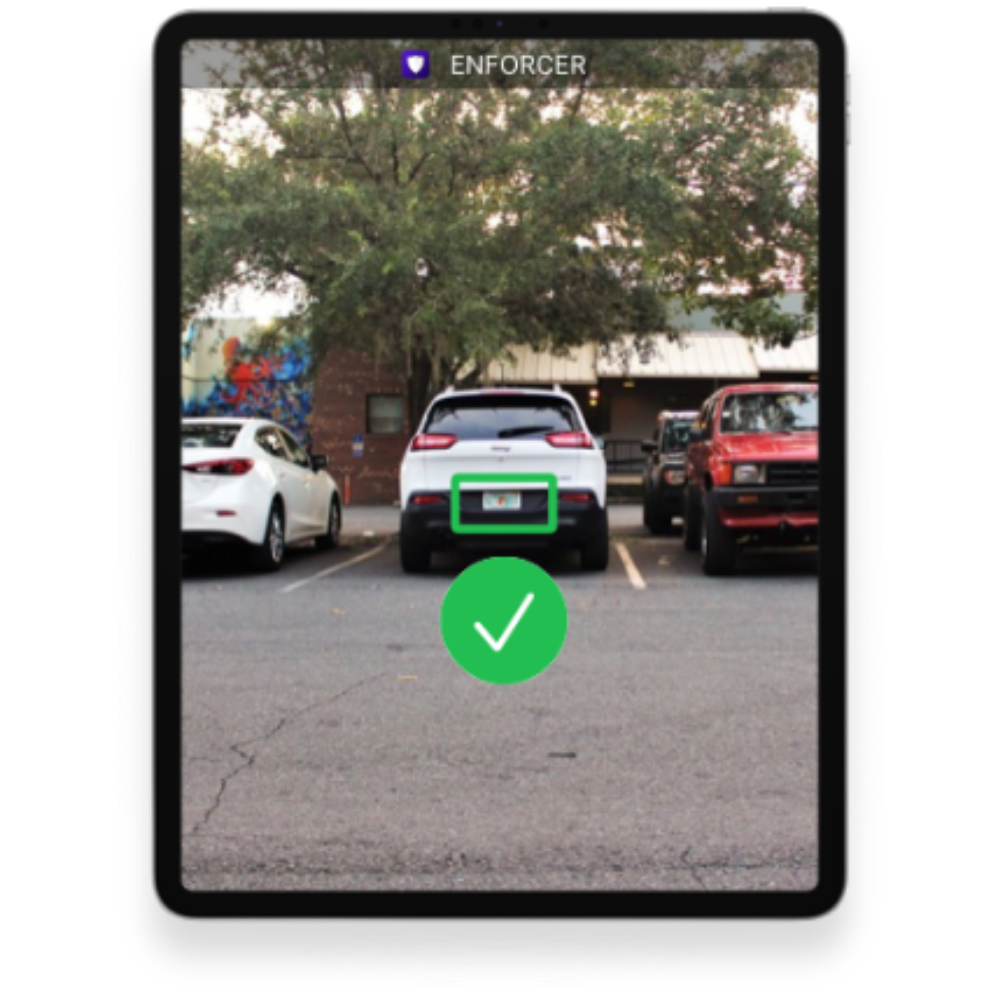 A parking lot with three cars parked, a tree in the background, and a mobile device screen showing a vehicle recognition app with a green check mark.