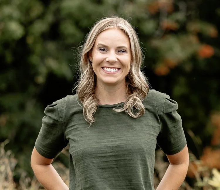 Headshot of Emily Zeller, LMFT and Certified Enneagram Consultant, smiling in a green top