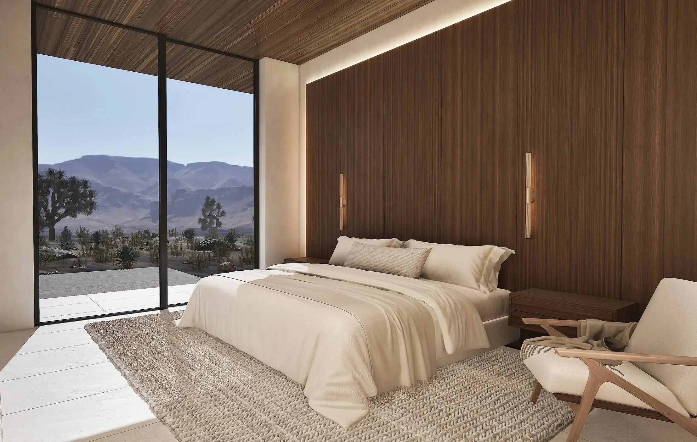 Primary bedroom at Shadow Wash Pavilion, a contemporary desert residence by Mystic Sand featuring floor-to-ceiling glazing, warm wood walls and ceiling, natural limestone flooring, and panoramic Mojave Desert mountain views.