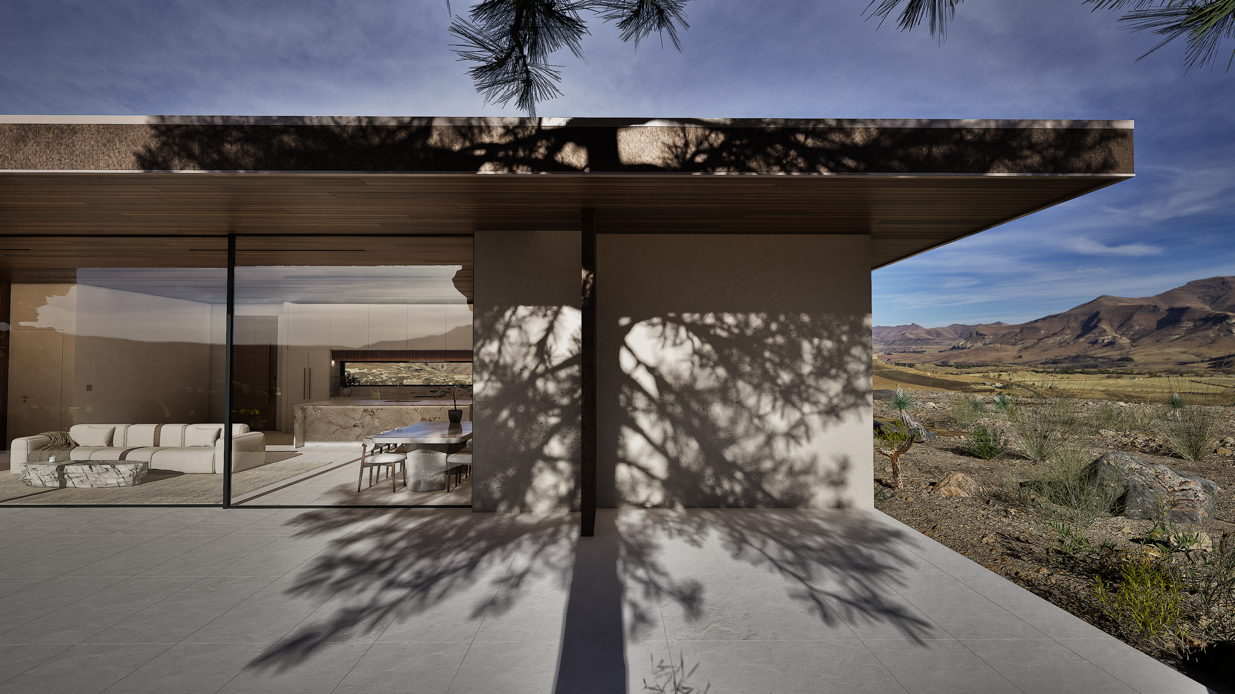 xterior view of Shadow Wash Pavilion by Mystic Sand in Twentynine Palms, California, featuring deep roof overhangs, floor-to-ceiling glazing, dramatic tree shadows, and seamless indoor-outdoor living overlooking the Mojave Desert.