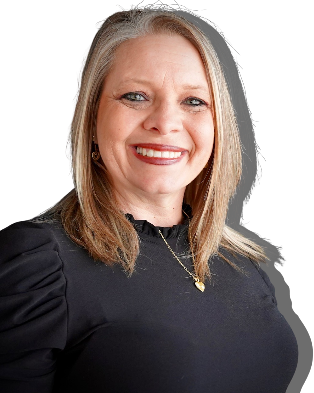 A smiling woman with blonde hair, wearing a black top and jewelry, against a black background.