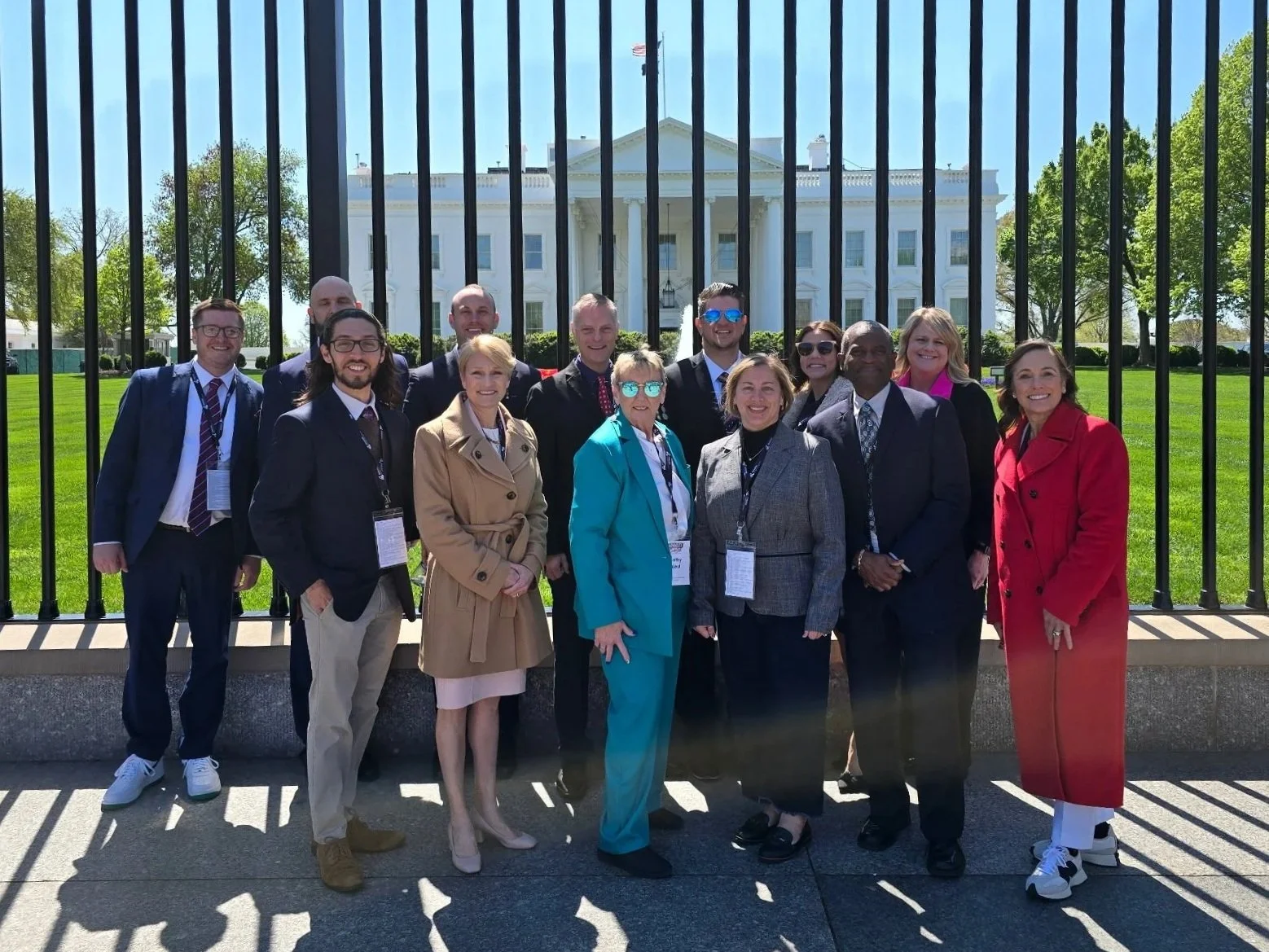 Group of business people standing in front of the White House in Washington, D.C.