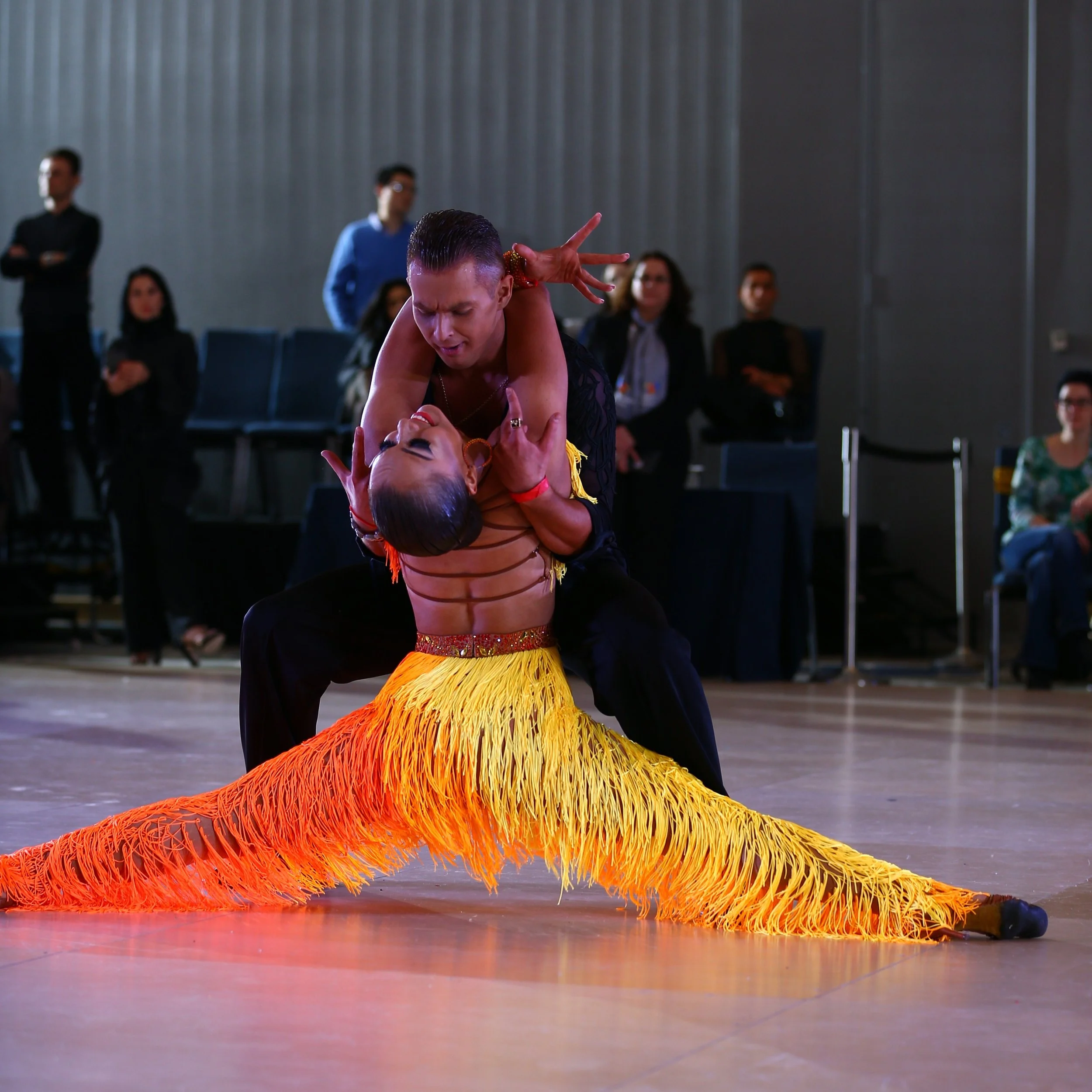 Two dancers performing a Latin dance