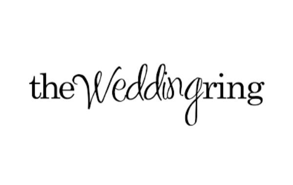 Black wedding-themed sign with the word "The Wedding" written in cursive.
