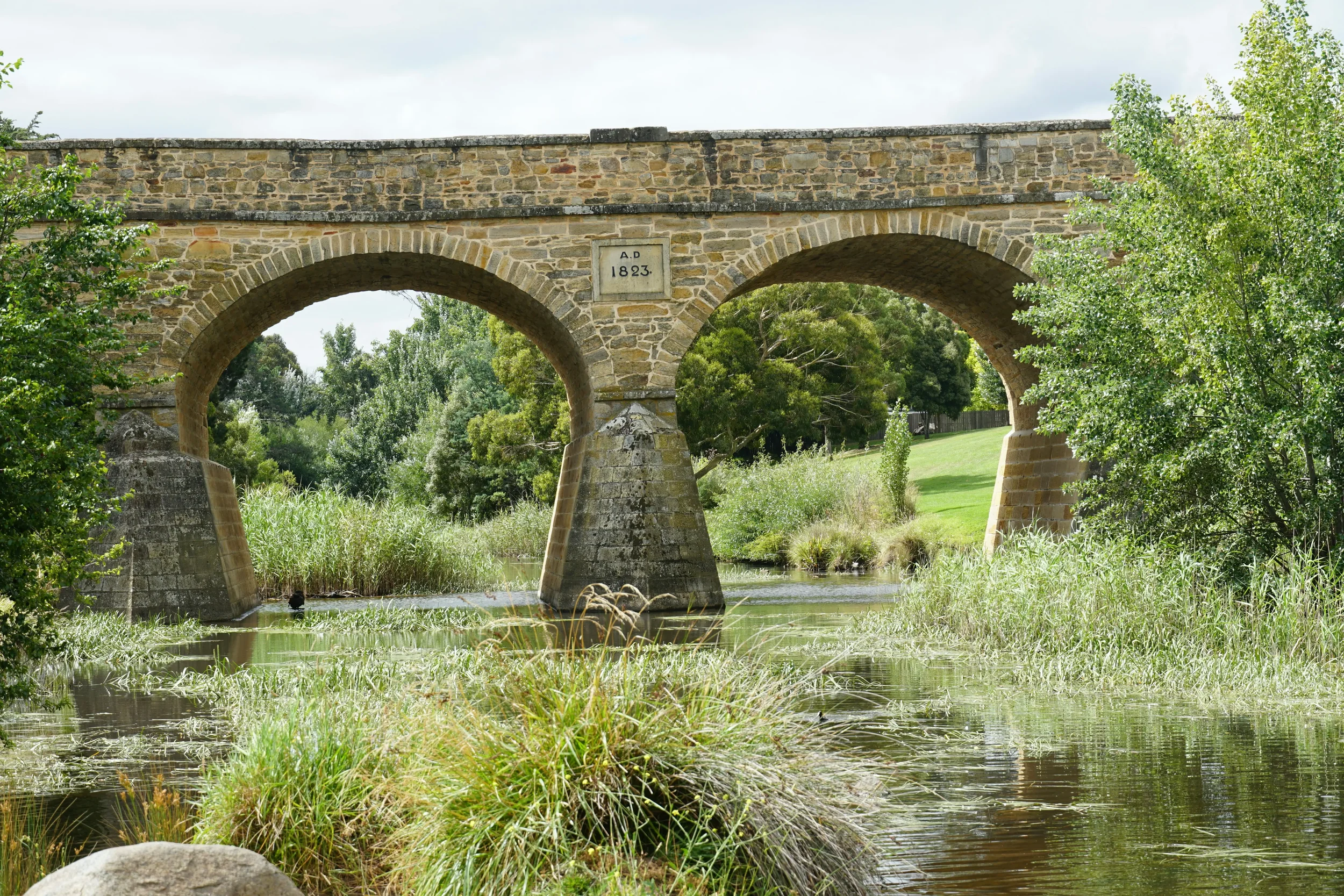 The historic Richmond Bridge in Tasmania, Australia, featuring classic sandstone arches built by convicts in the early 19th century.