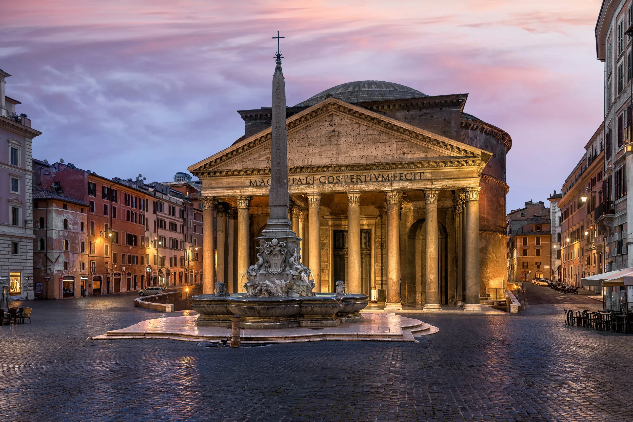 The ancient Roman Pantheon with its iconic portico and Corinthian columns, seen from the crowded Piazza della Rotonda.