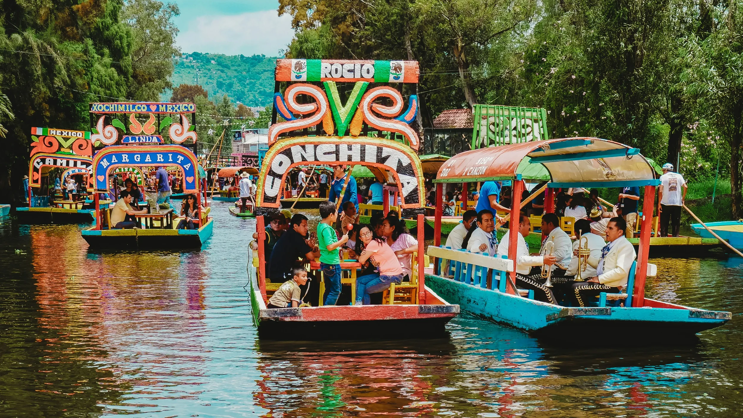 Traditional colorful wooden boats called Trajineras docked at the Xochimilco canals, a UNESCO World Heritage site in Mexico City.