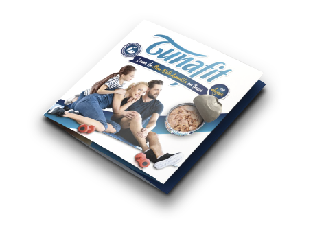 A magazine titled 'Tuna Fish' sitting on a black surface, featuring a family sitting on the floor, a bowl of tuna, and a can of tuna on the cover.