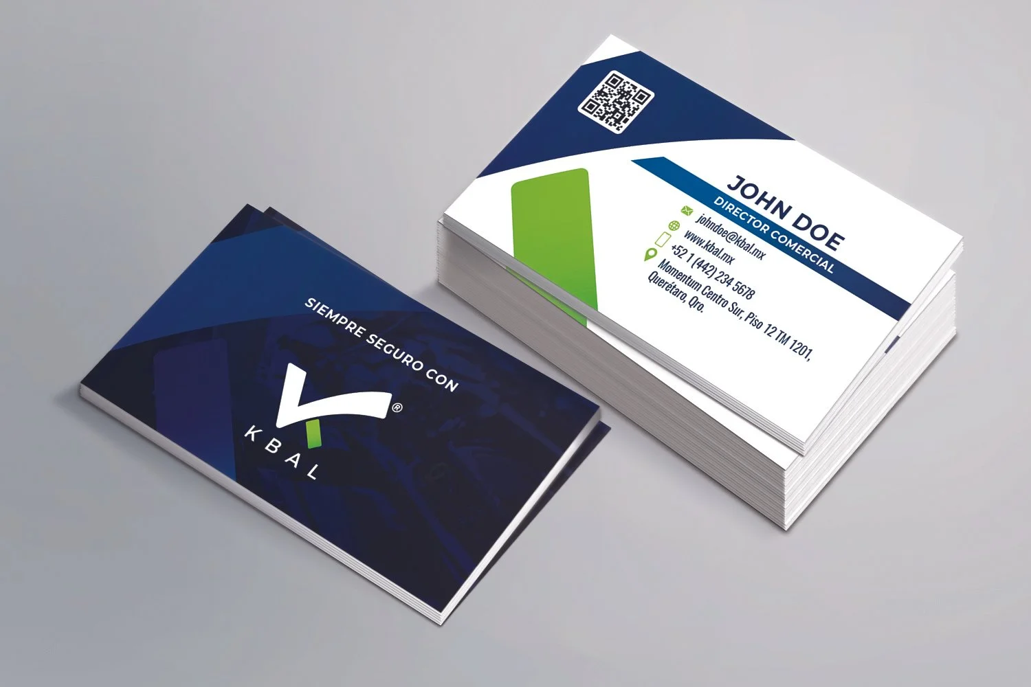 Stack of business cards, one with contact information for John Doe, a commercial director, and another with a logo and slogan of Kbal security company.
