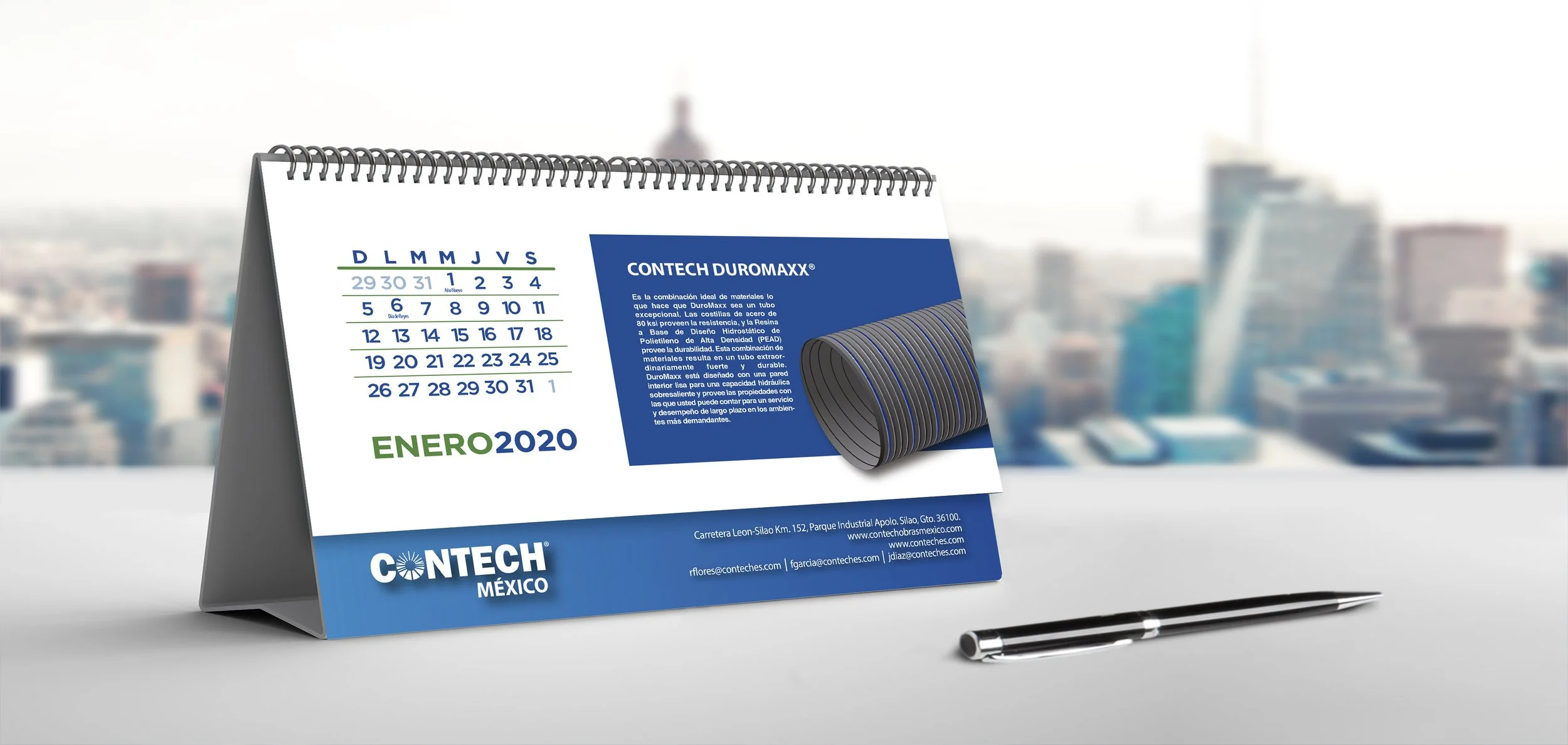 Desk calendar showing January 2020 with a blue Conteh Mexcio advertisement and a pen on a white surface with a cityscape in the background.