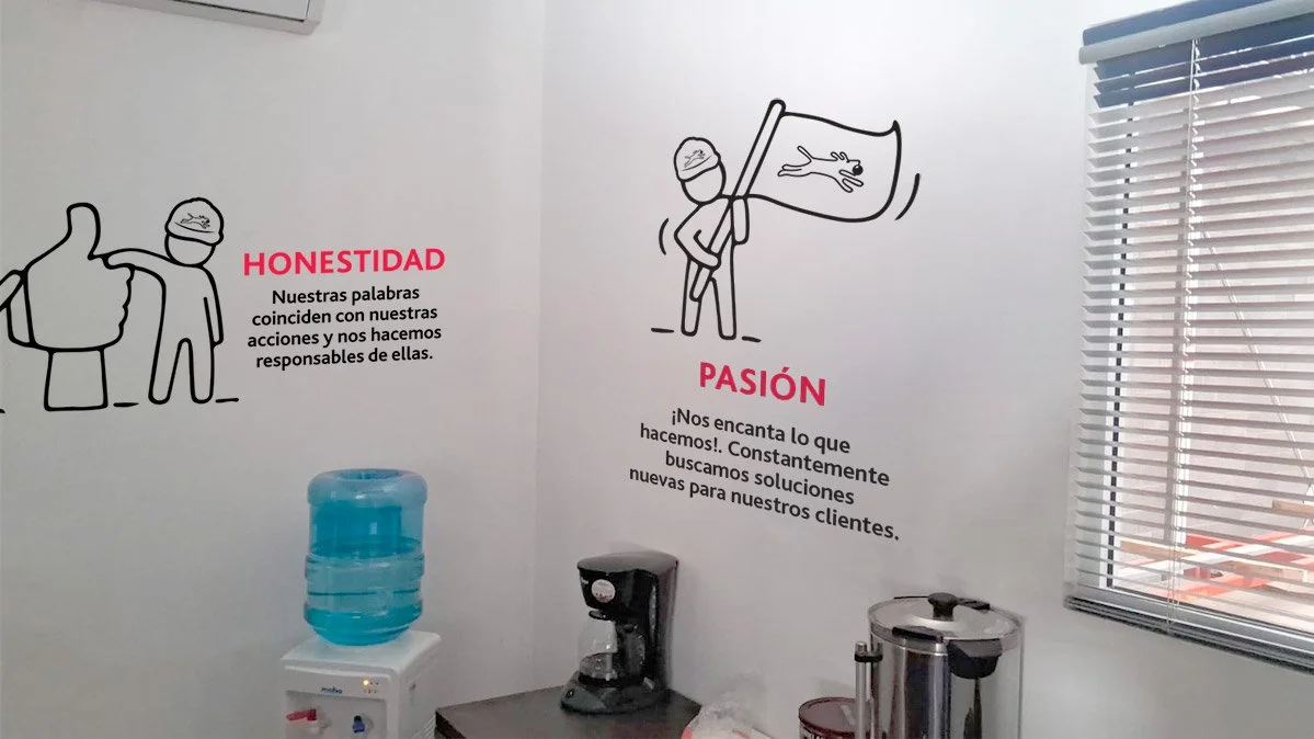 Office wall with motivational messages in Spanish, illustrations of a person giving a thumbs-up, holding a flag, and smiling, a water cooler, coffee machine, and a window with blinds.