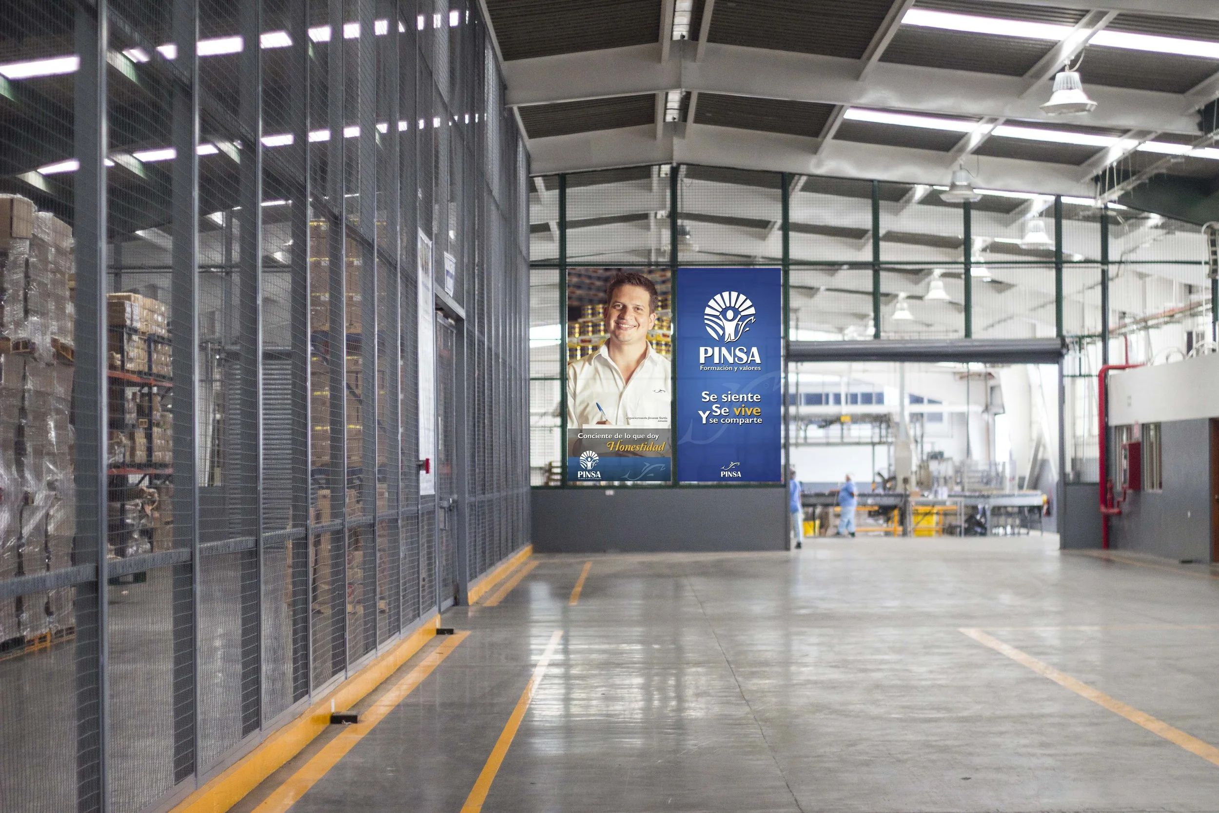 Industrial warehouse with shelves of stored goods on the left, a large PINSA advertisement featuring a smiling man in the background, and workers in safety gear in the distance