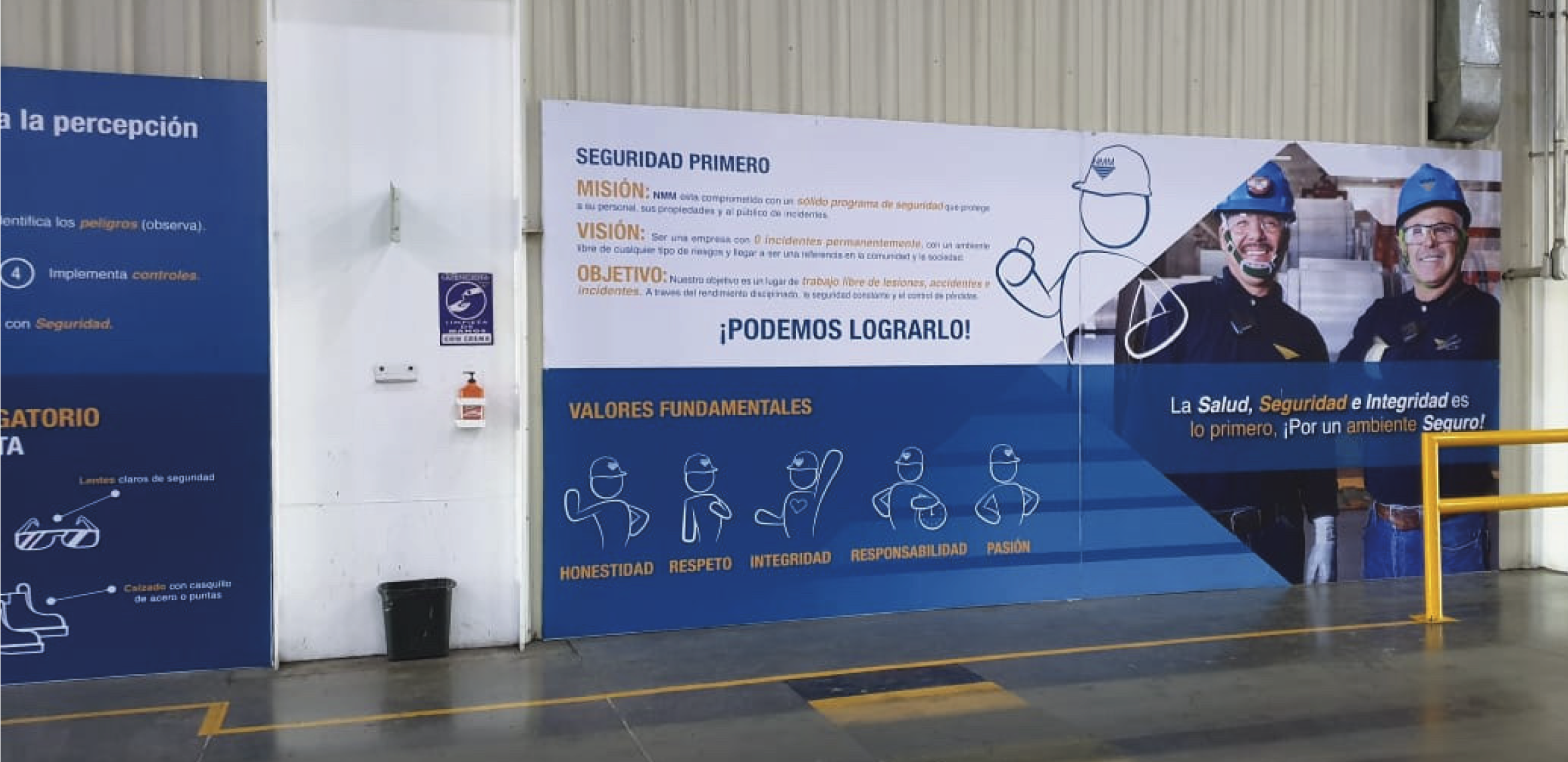A safety awareness poster at a workplace with a group of workers wearing safety helmets. The poster emphasizes the importance of health, safety, and integrity, outlining core values such as honesty, respect, integrity, responsibility, and passion. It