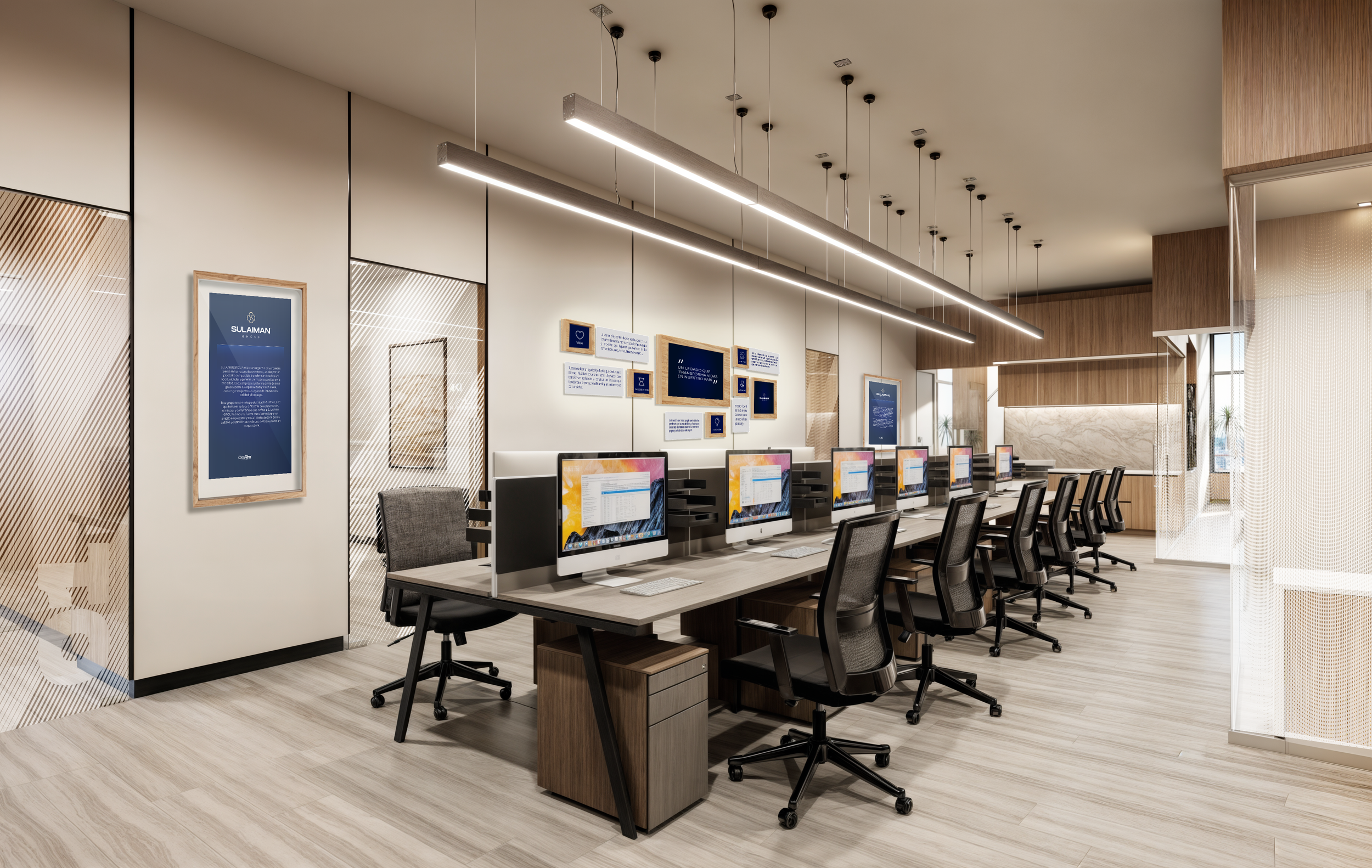 A modern office space with a long row of desktop computers and black swivel chairs, featuring wood and glass decor with wall-mounted screens and bright lighting.