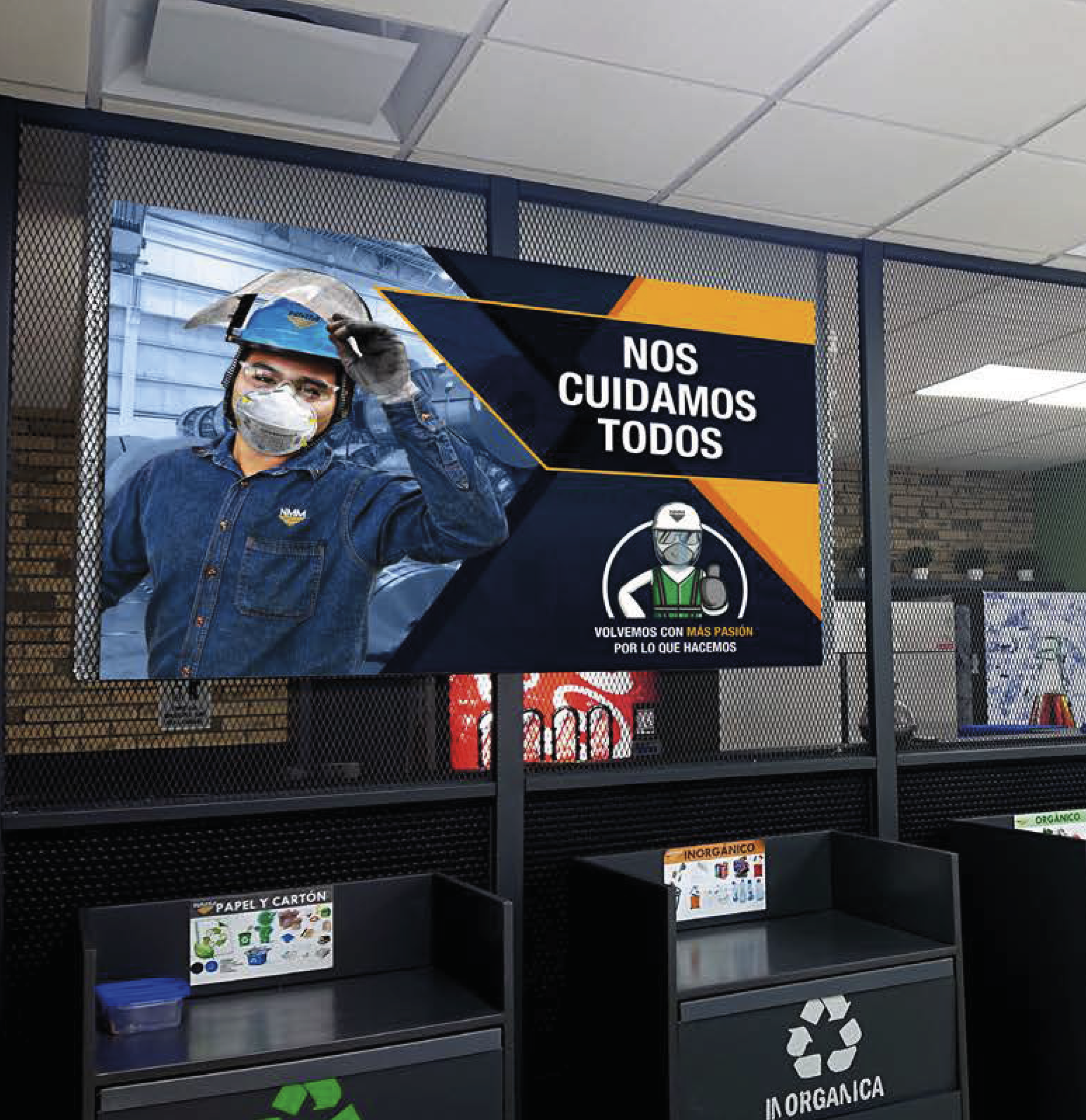 A poster in Spanish with a worker wearing a helmet and a face mask, and text that reads 'Nos Cuidamos Todos'. The poster also features an illustration of a worker wearing safety gear, and additional text 'Volvemos con más pasión por lo que hacemos'. 