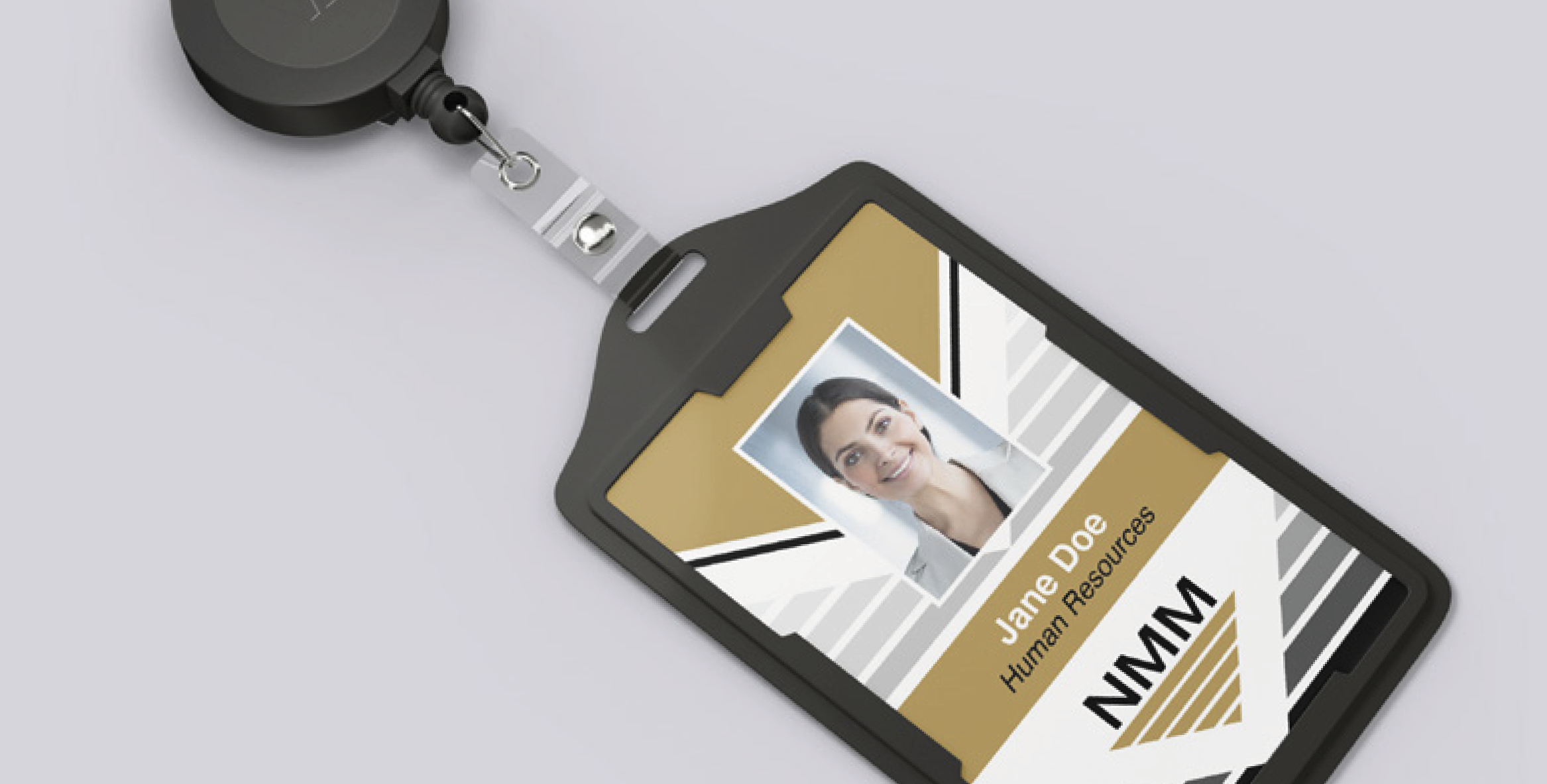 ID badge with photo, name Jane Doe, Human Resources, and NMW logo, attached to a badge reel