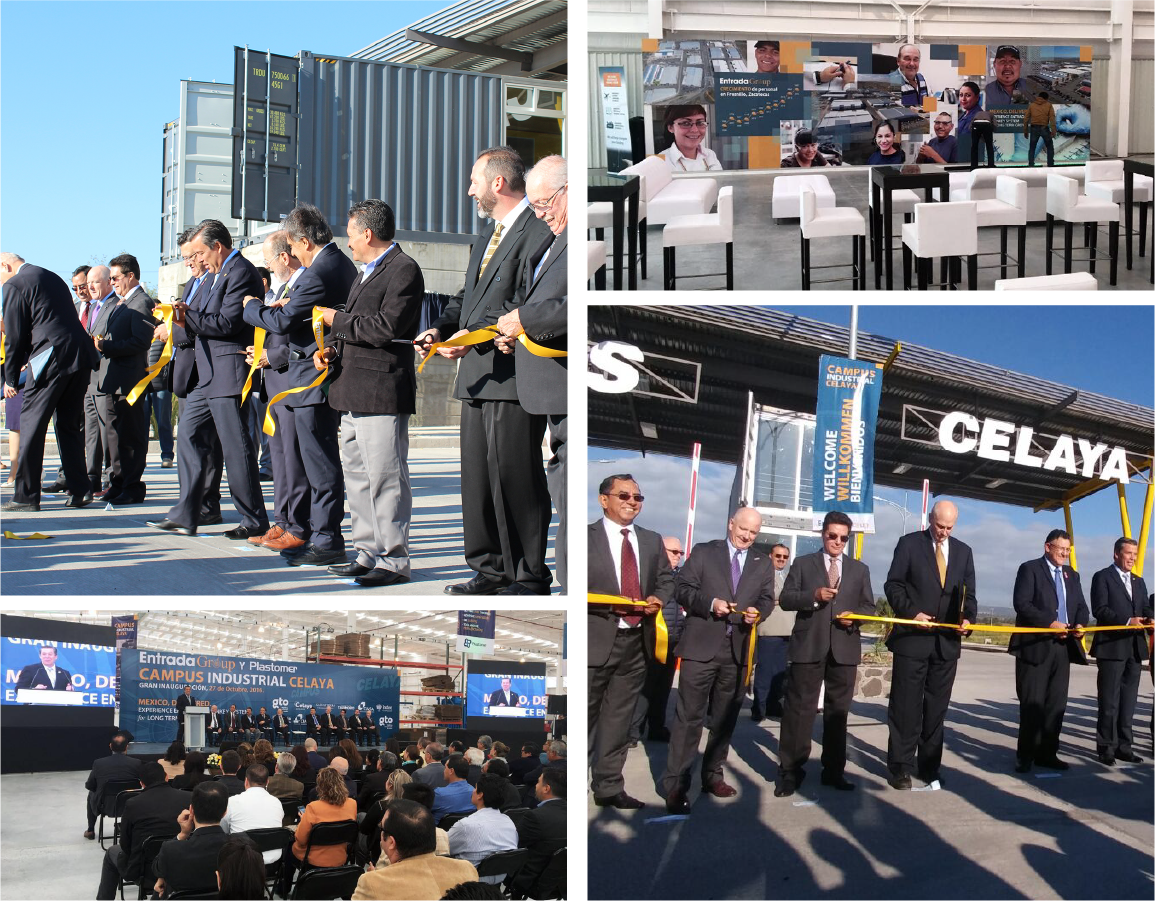 Group of men in suits participating in an outdoor ribbon-cutting ceremony at a new industrial facility, with a stage and audience indoors for the event, and a display booth with seating inside.