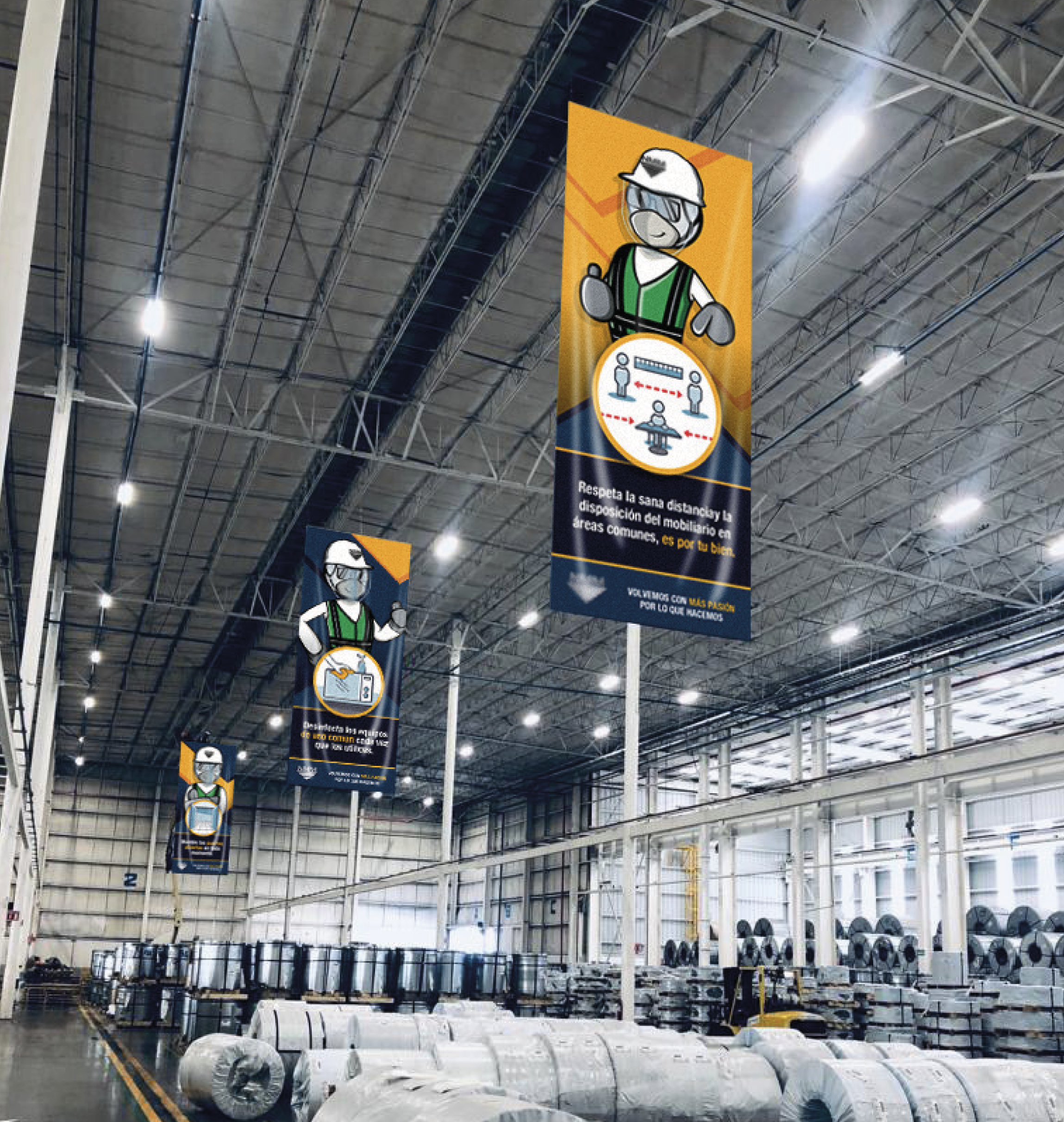 Interior of a large industrial warehouse with hanging safety banners promoting health guidelines. The warehouse contains large rolls of materials stored on racks along the back wall, with bright overhead lighting and a high curved ceiling.
