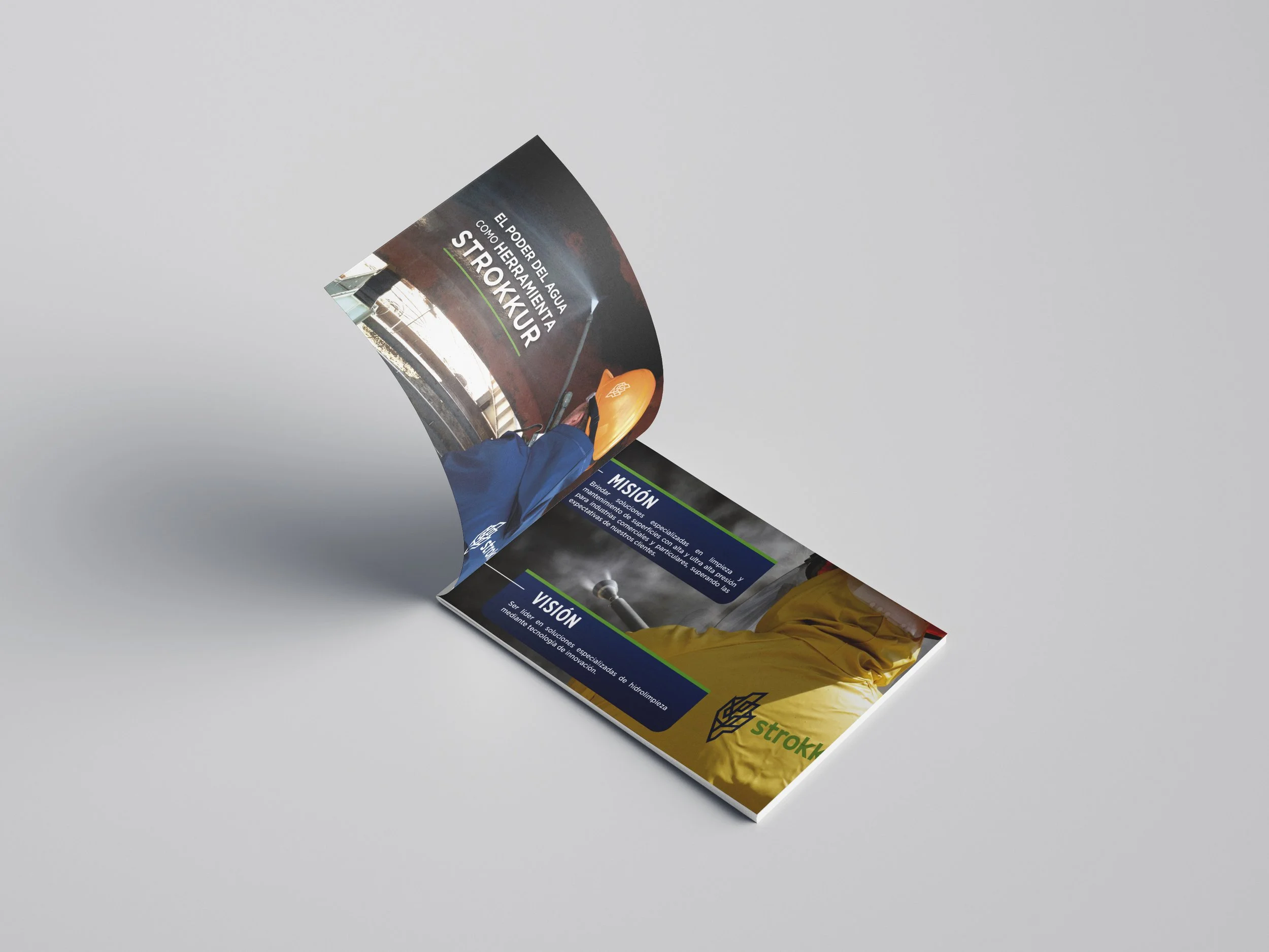 Open brochure showcasing information about Strokku, water-powered rail systems, with images of trains and infrastructure, placed on a plain surface.