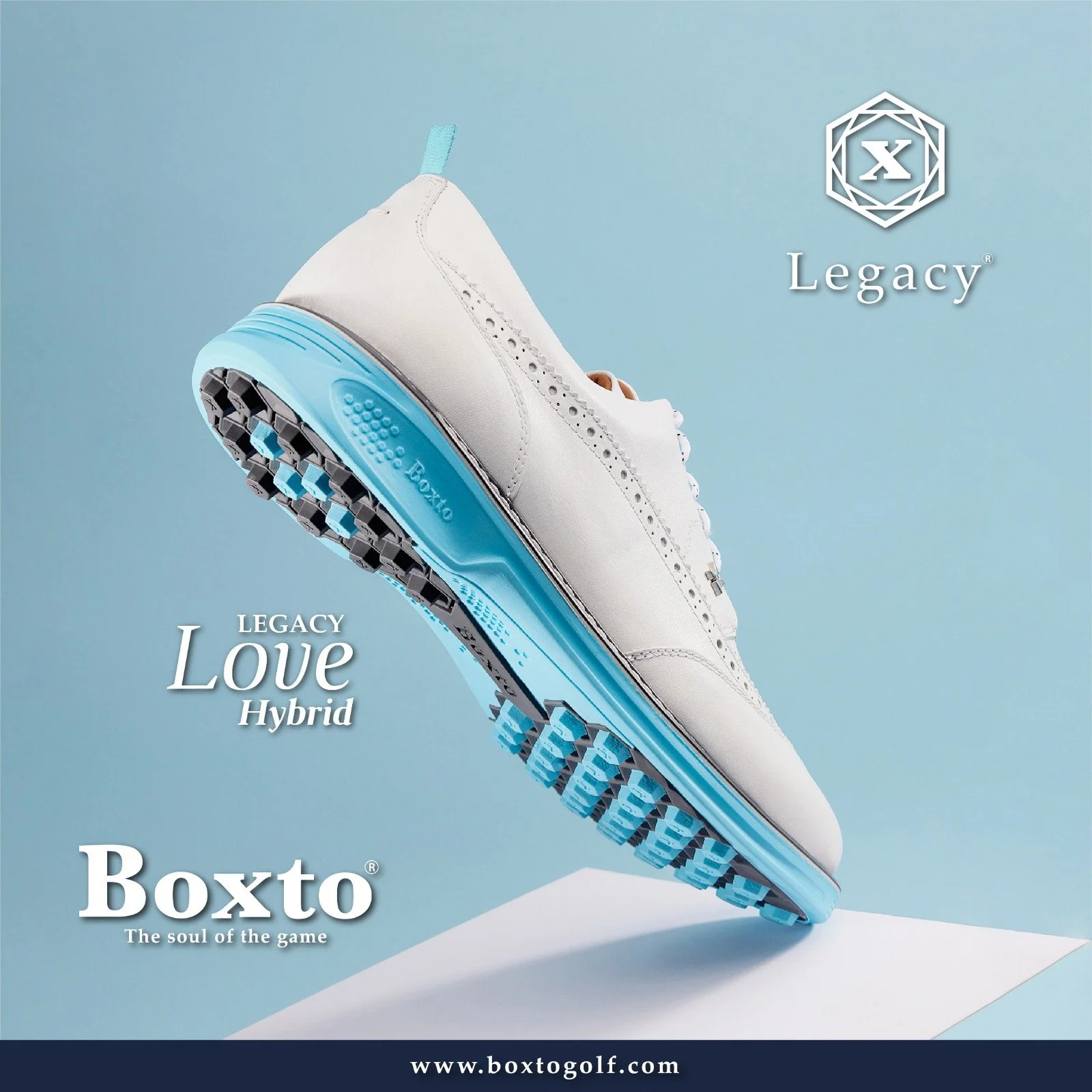White golf shoe with light blue sole and black grips, floating above a white surface, with the text 'Legacy Love Hybrid' and the website 'www.boxtogolf.com'.