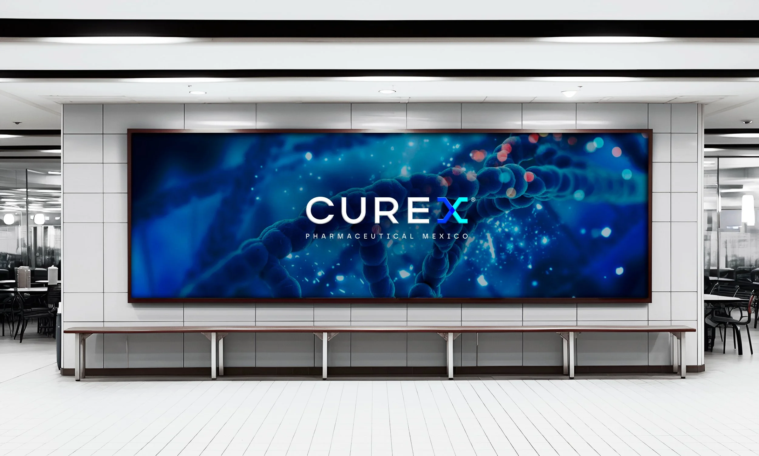 Large digital screen displaying the logo of CUREX and the words Pharmaceutical Mexico, with a background of blue DNA strands and sparkles, in a modern indoor setting with white tiled walls and seating area.