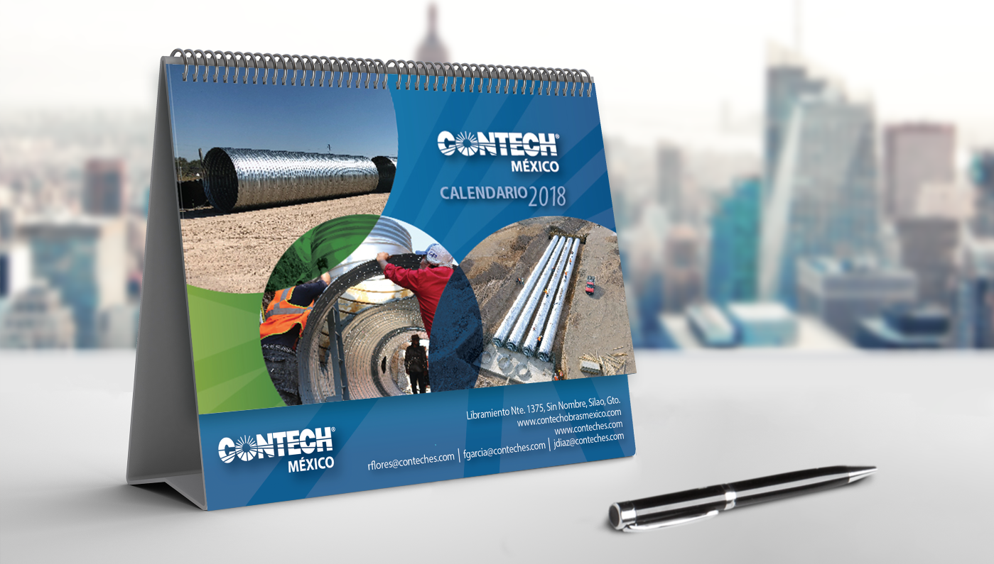 A blue desk calendar for 2018 with images of construction involving pipes and large rolled metal sheets, displaying the logo and contact information for Contech México.