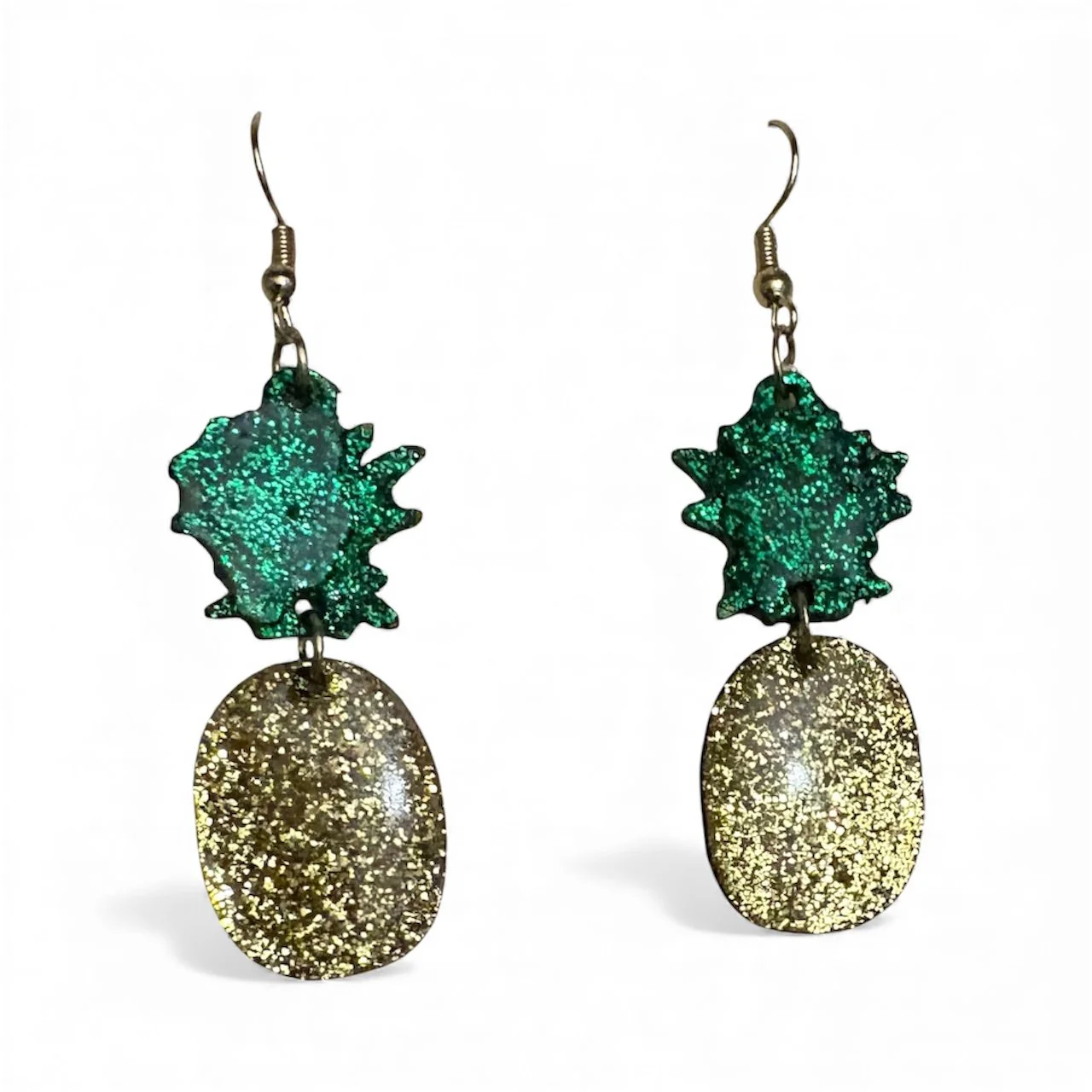 Pair of earrings with glittery green and gold oval shapes connected by a star-shaped green piece.