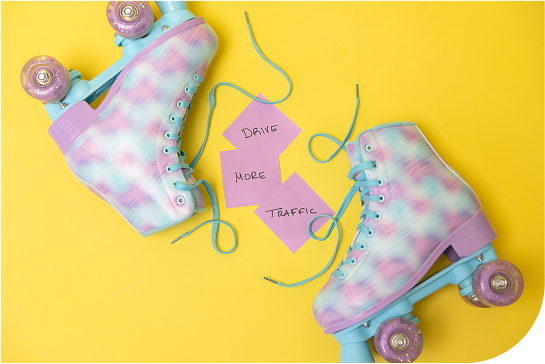 yellow background with purple roller skates laying down