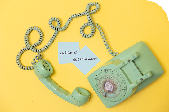 green rotary telephone on a yellow background